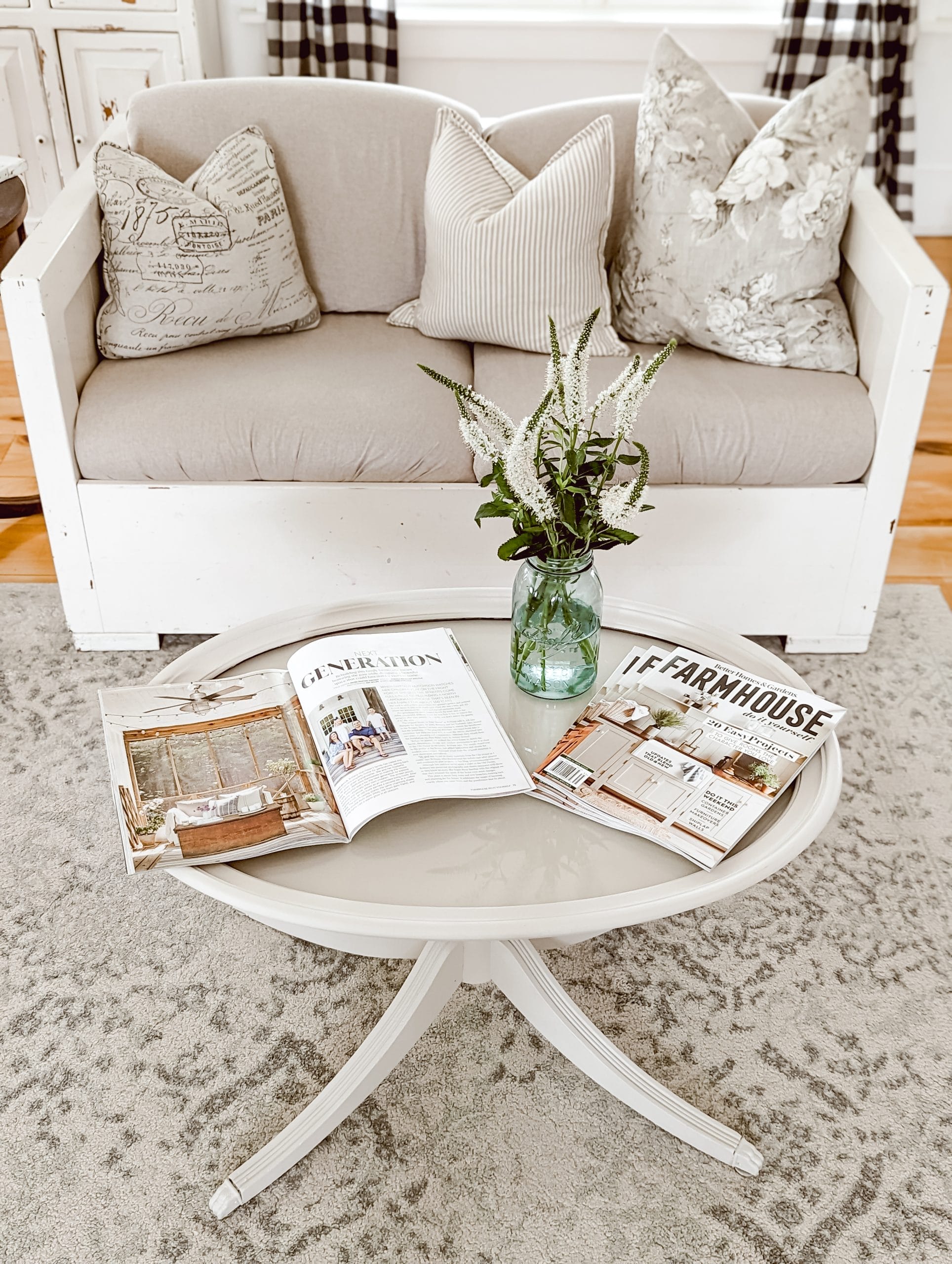 glass top oval pedestal style coffee table painted the color cashmere