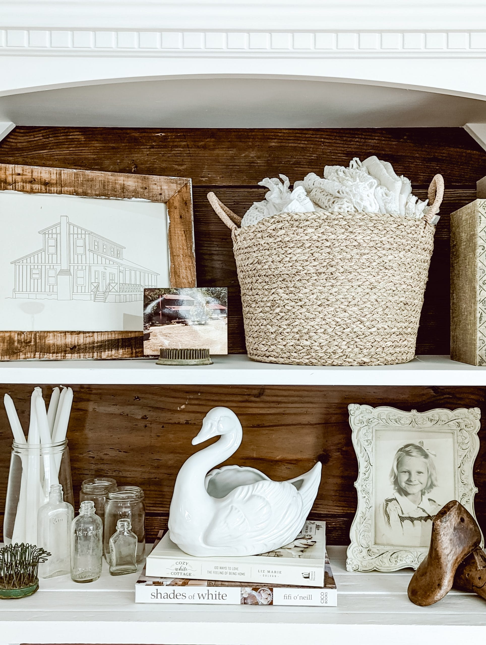 vintage ceramic swan planter styled on a bookshelf with other thrifted cottage farmhouse style decor finds