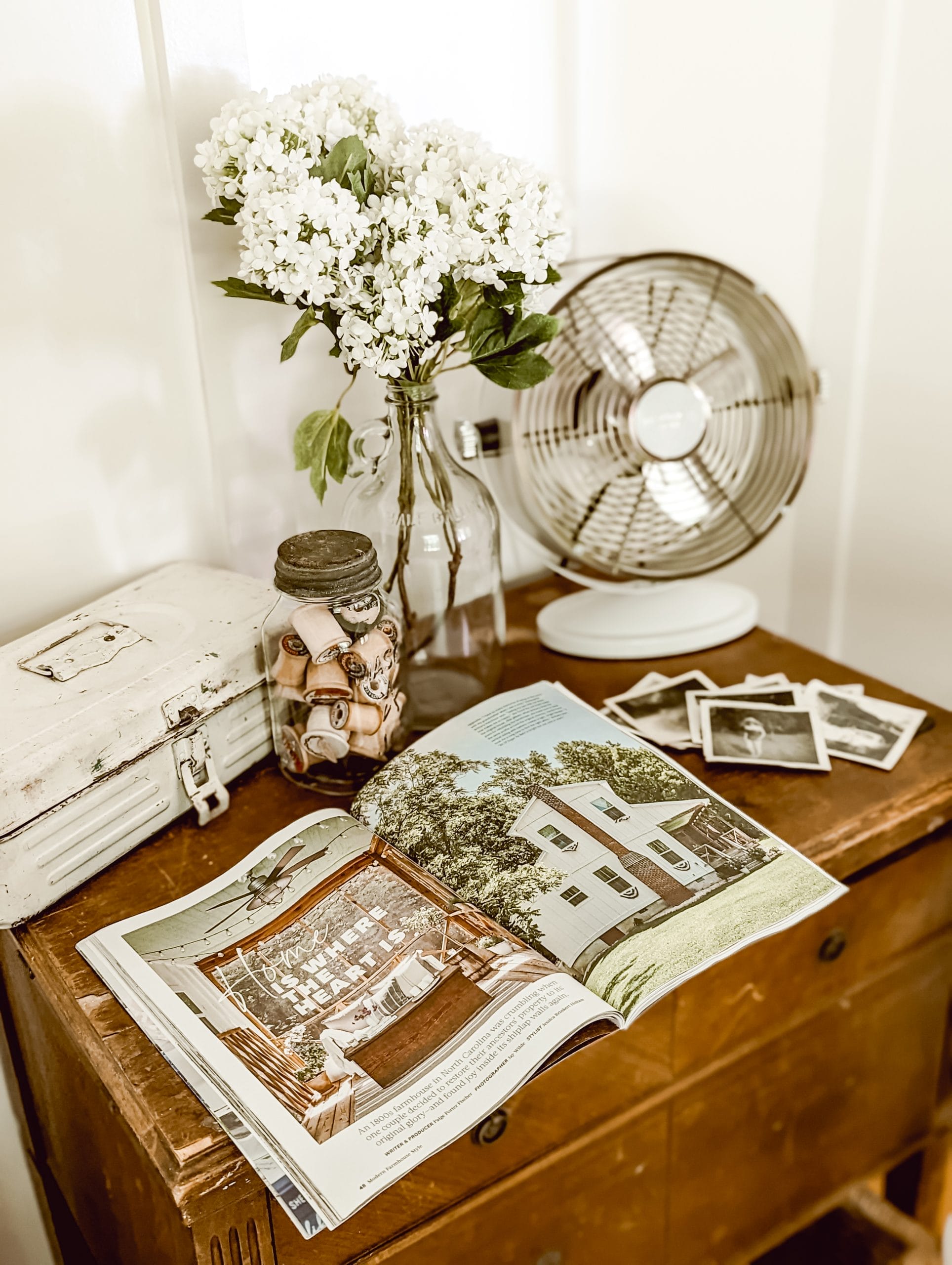 our farmhouse's feature article in Modern Farmhouse Style Magazine laying open on a wood cabinet