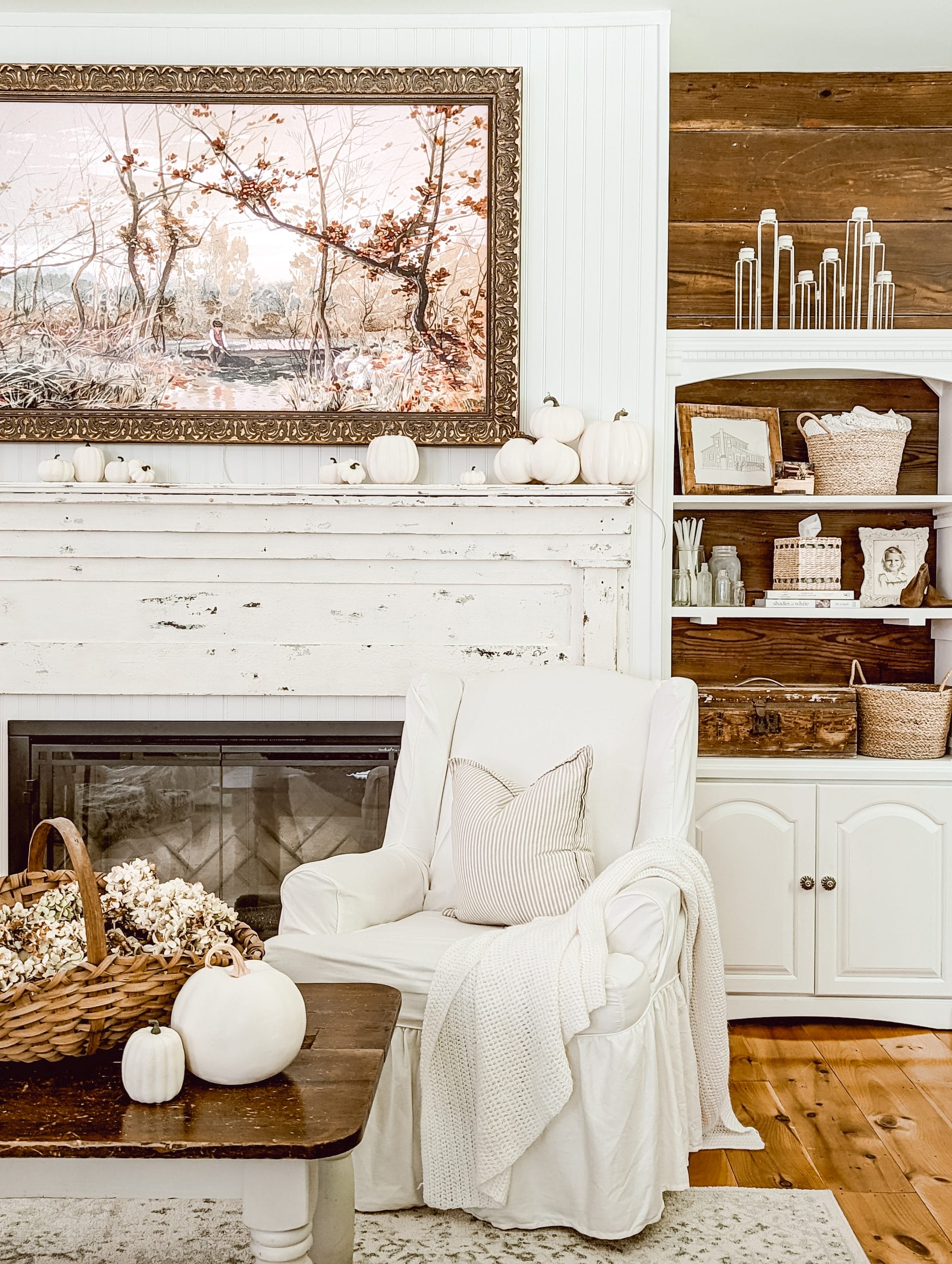 simple fall mantel decor in a white and wood farmhouse living room
