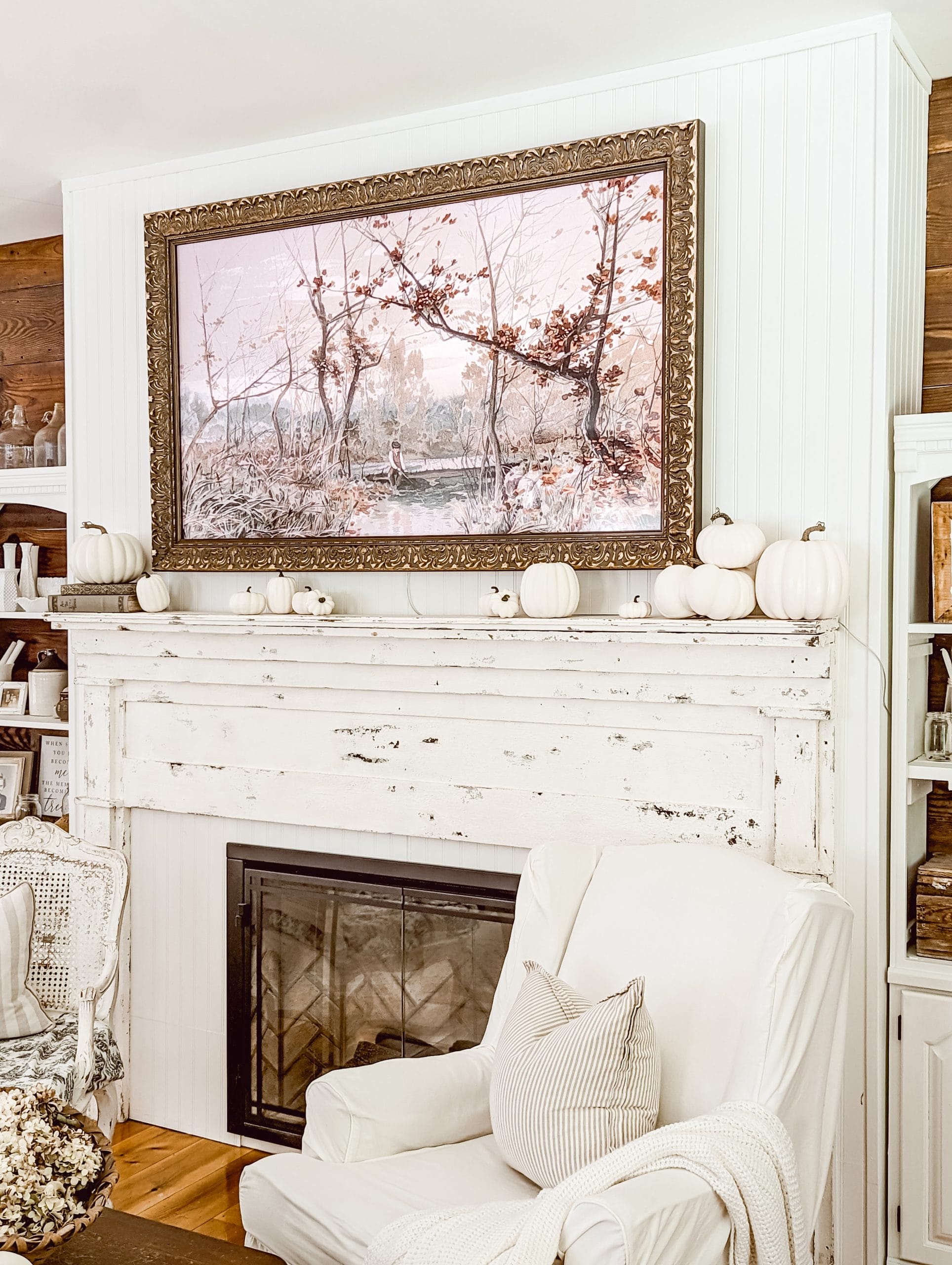 simple fall mantel decor in a white and wood farmhouse living room