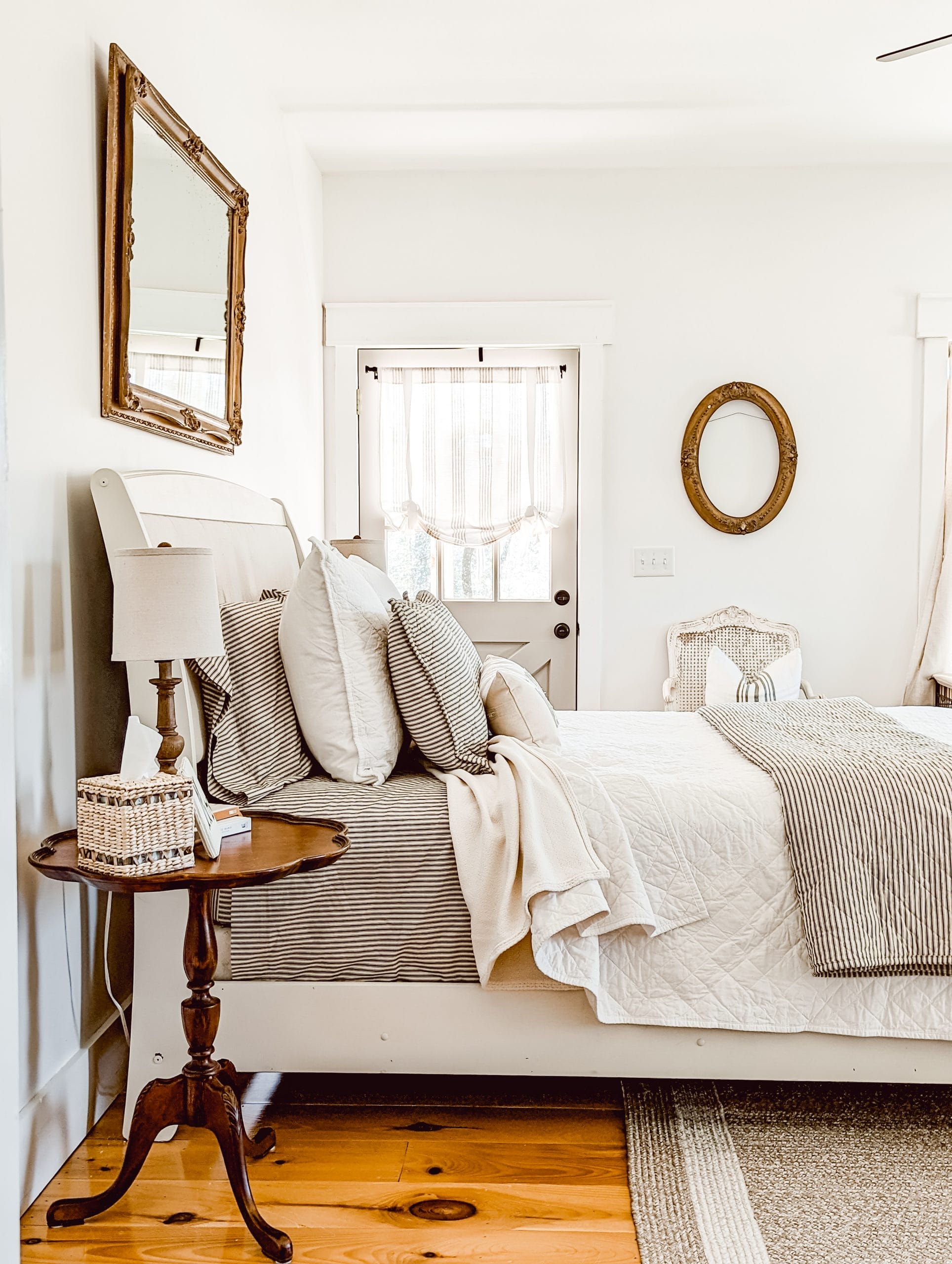 Glossy black headboard painted white in the color Raw Silk by Fusion Mineral