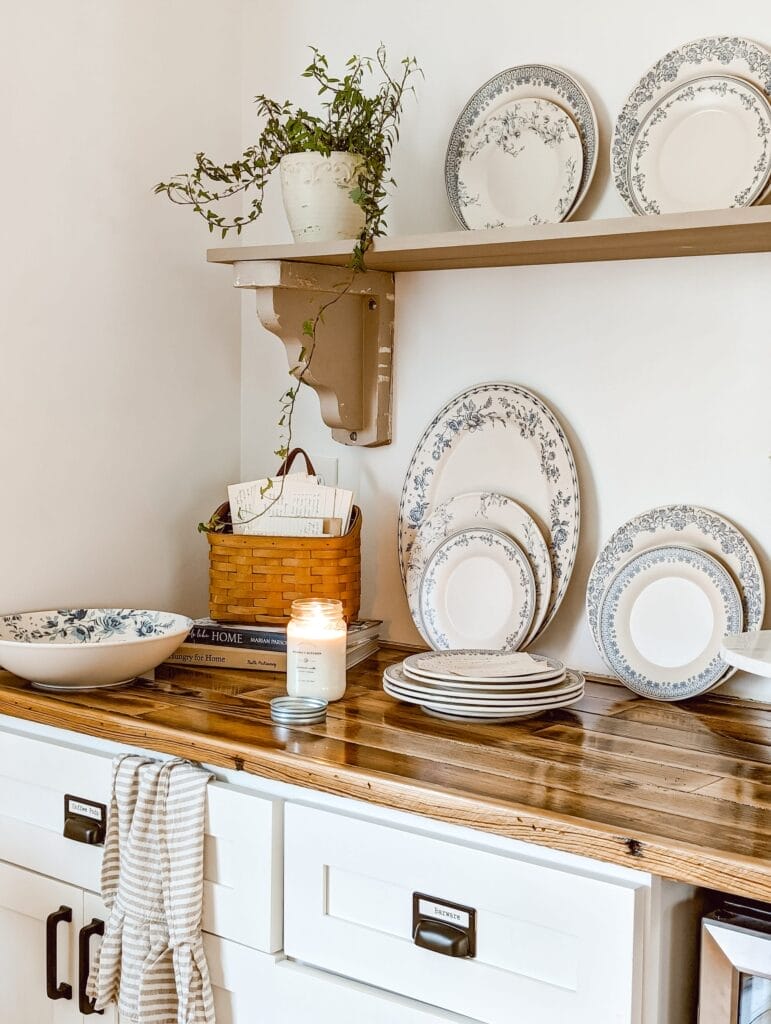 farmhouse coffee bar with white cabinets and wood countertops and a built in corbel shelf