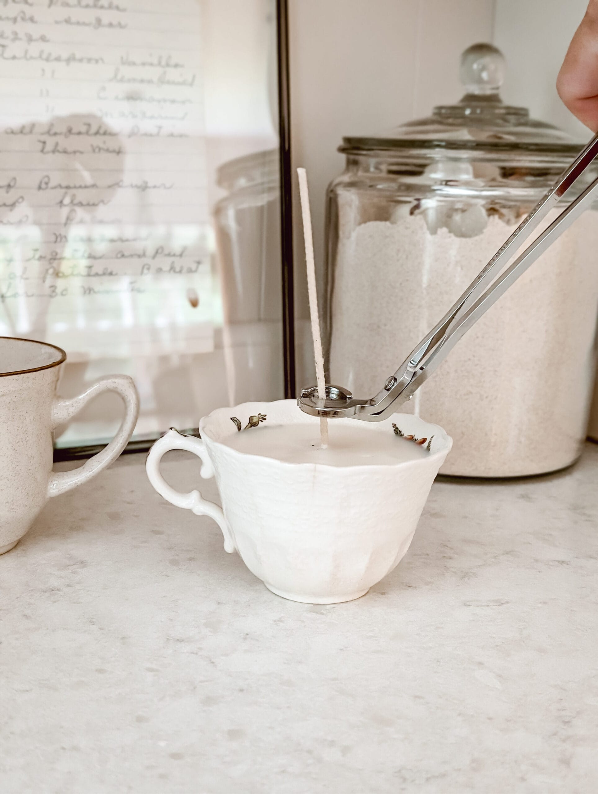 trimming the wick on a DIY vintage teacup candle