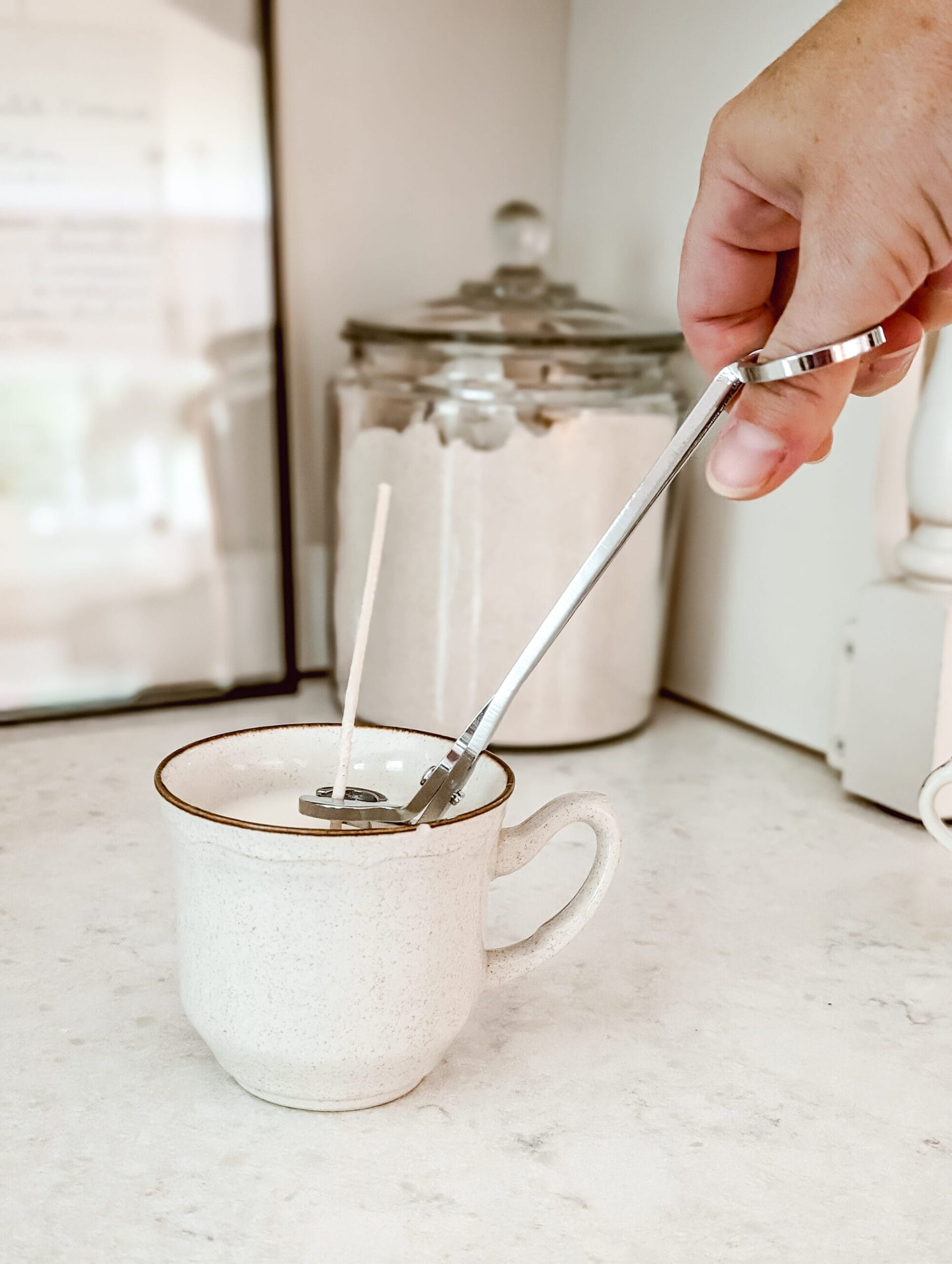trimming the wick on a DIY vintage teacup candle