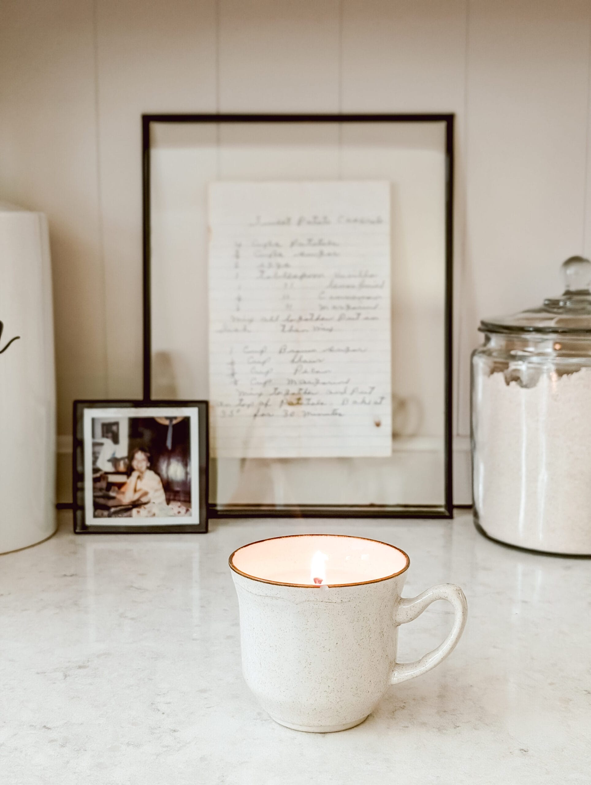DIY vintage teacup candle in a which speckled cup with a brown rim
