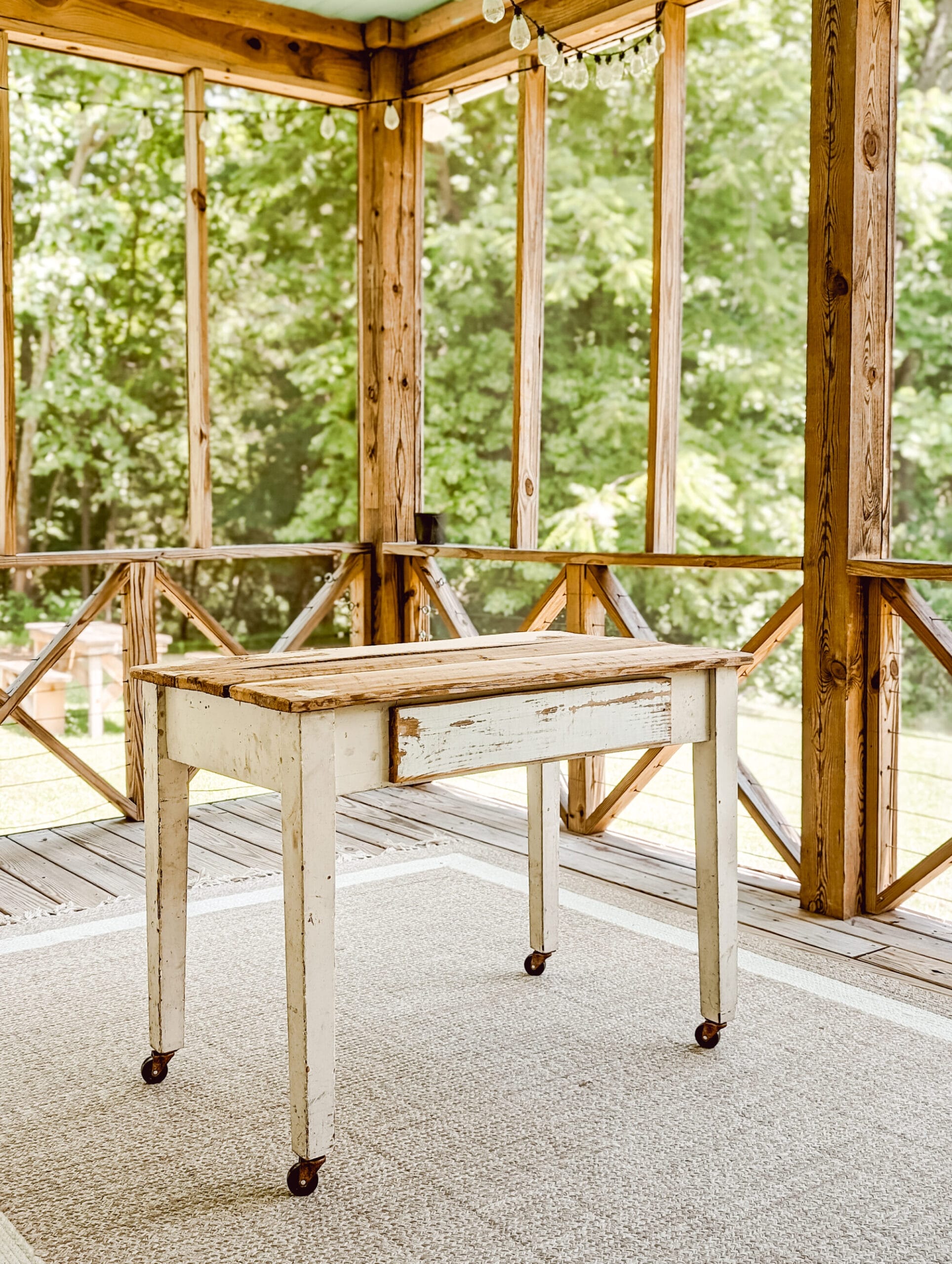 rolling porch table on caster wheels sitting on a screened in porch