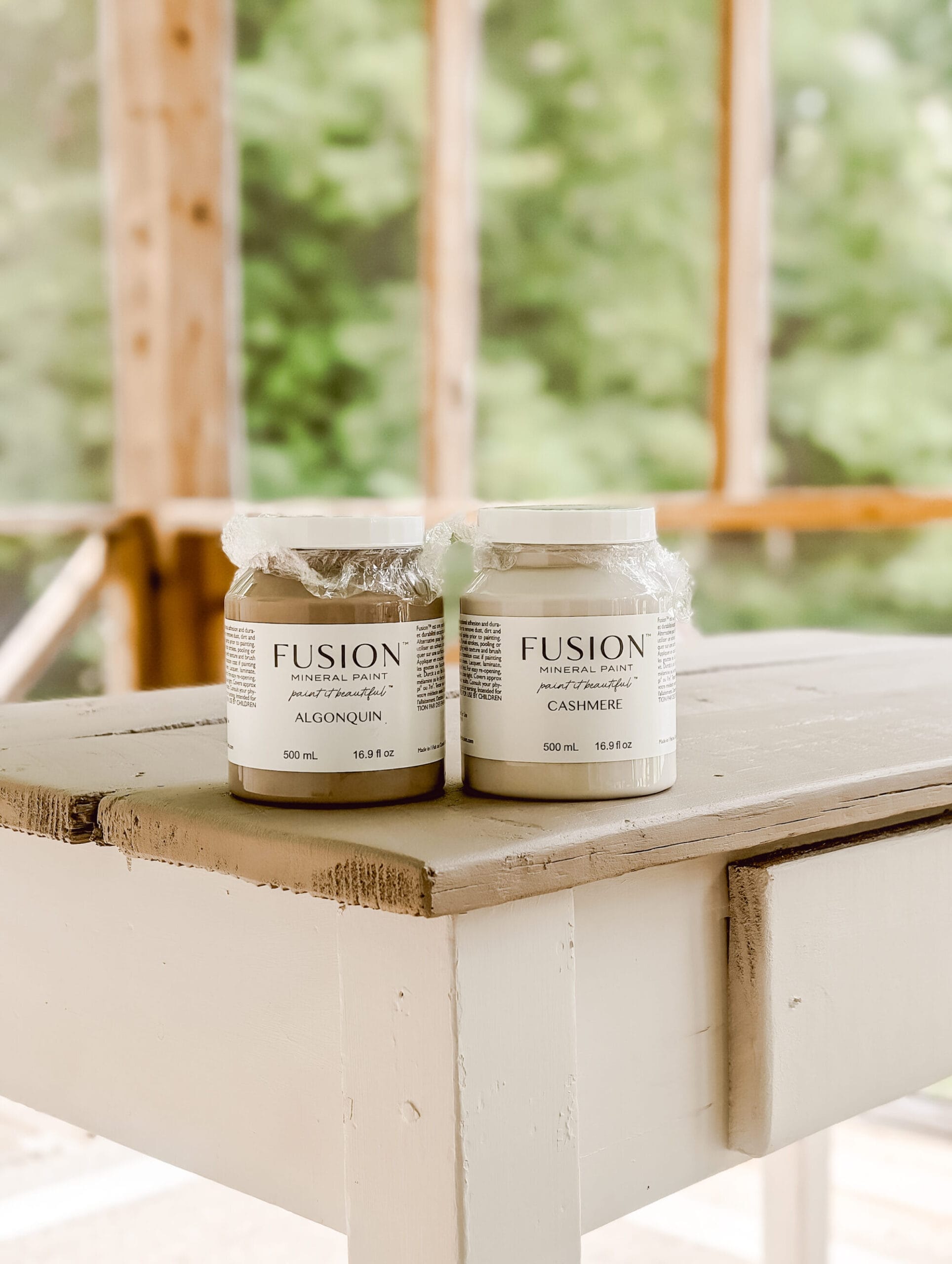 a container of Algonquin and a container of Cashmere by Fusion Mineral Paint