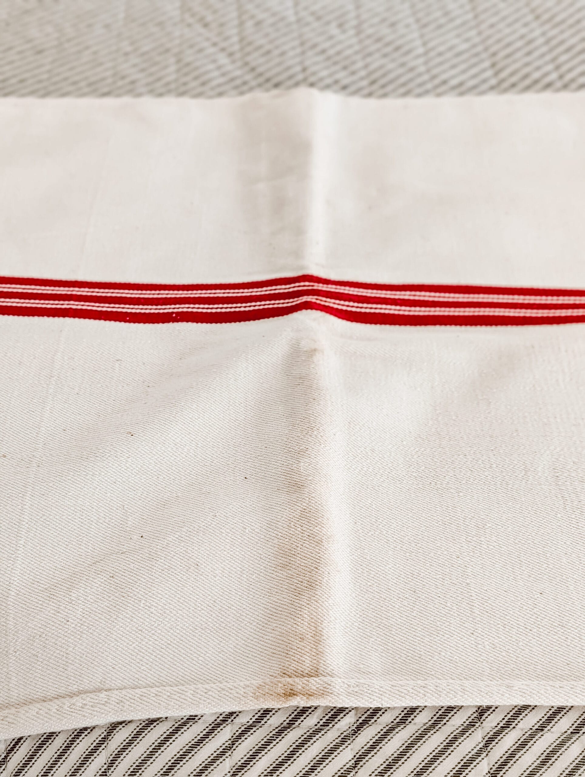 close up details of an antique grain sack with red and white stripes
