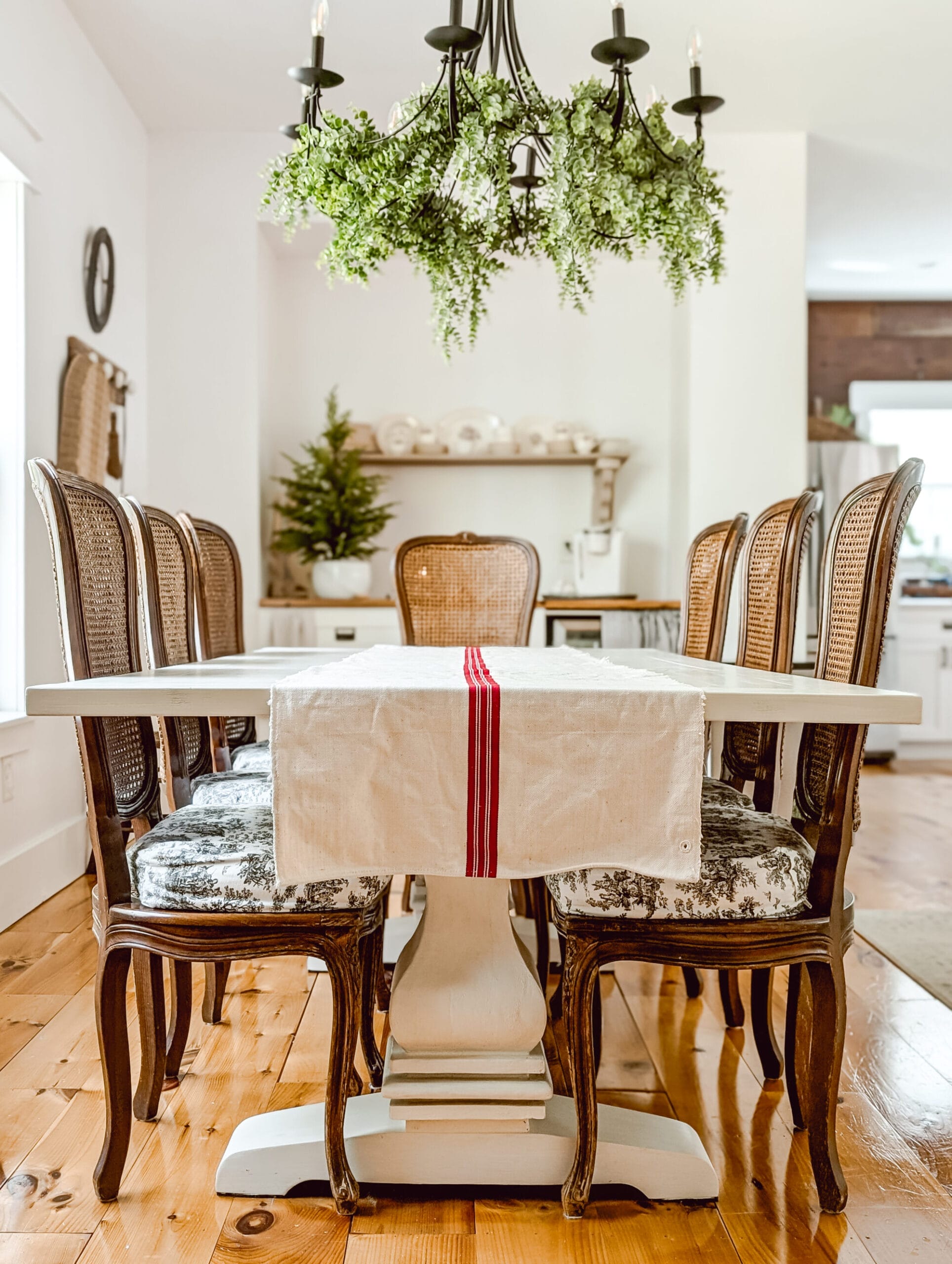 antique grain sack table runner on a white painted farmhouse trestle table