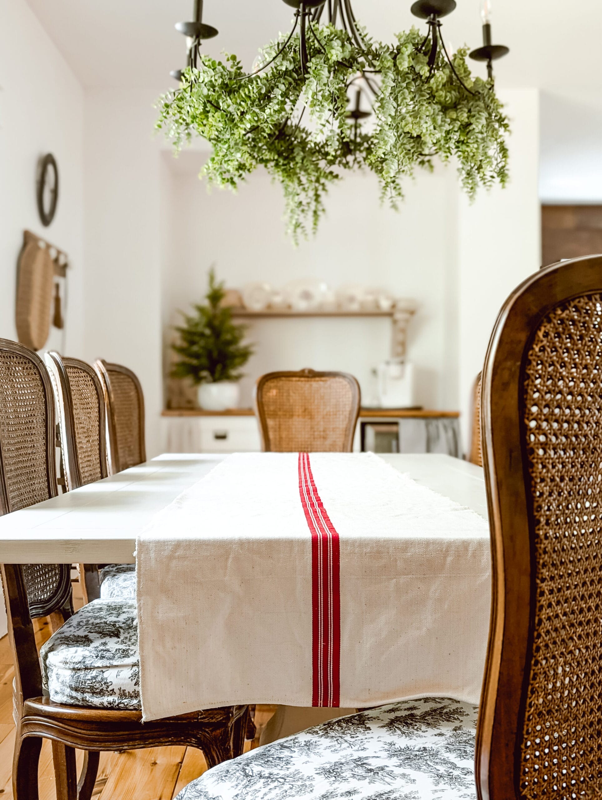antique red and white grain sack re-purposed as a festive Christmas table runner