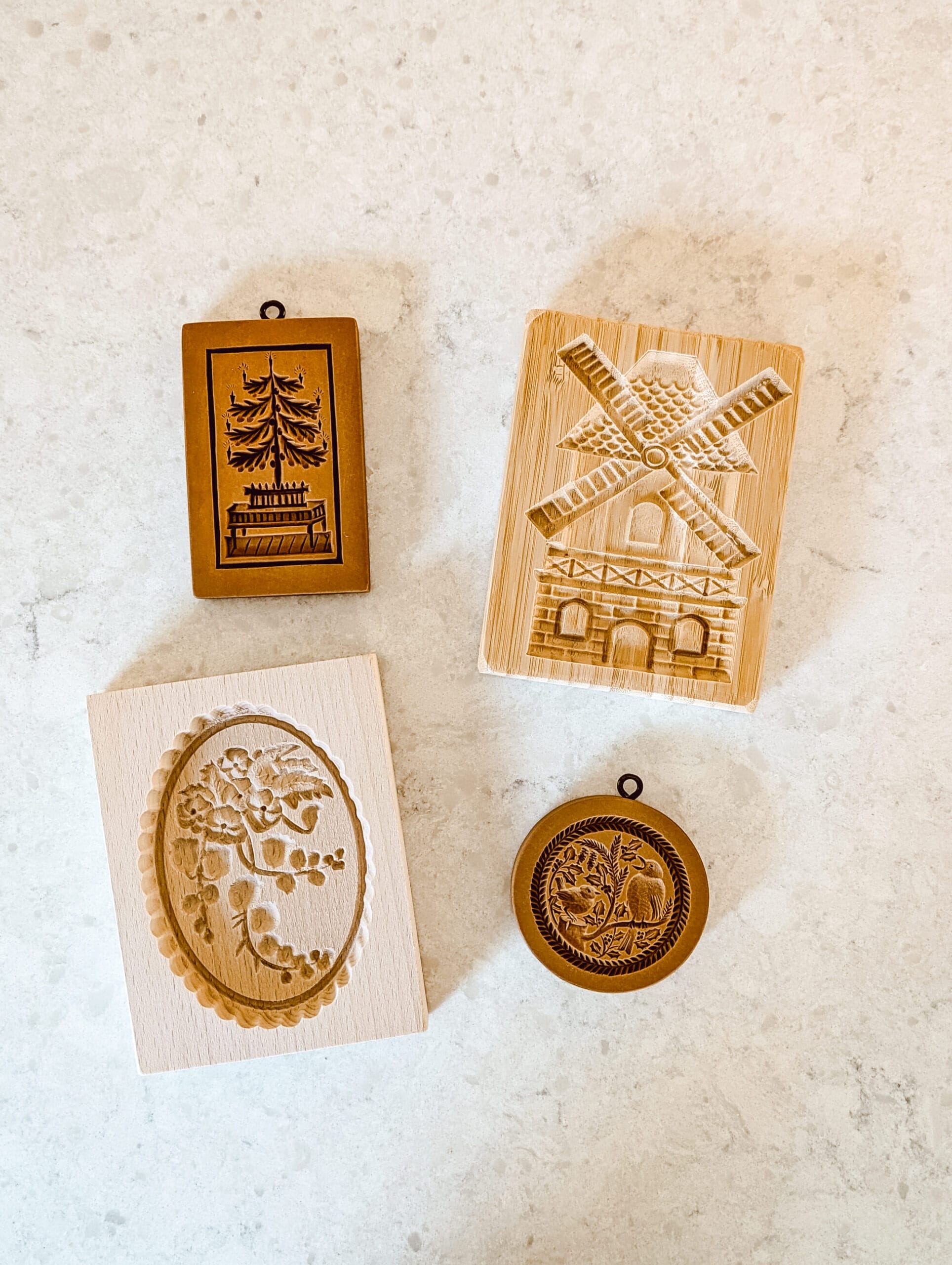 4 wooden springerle molds - a Christmas tree, a Dutch windmill, winter birds, and a floral oval