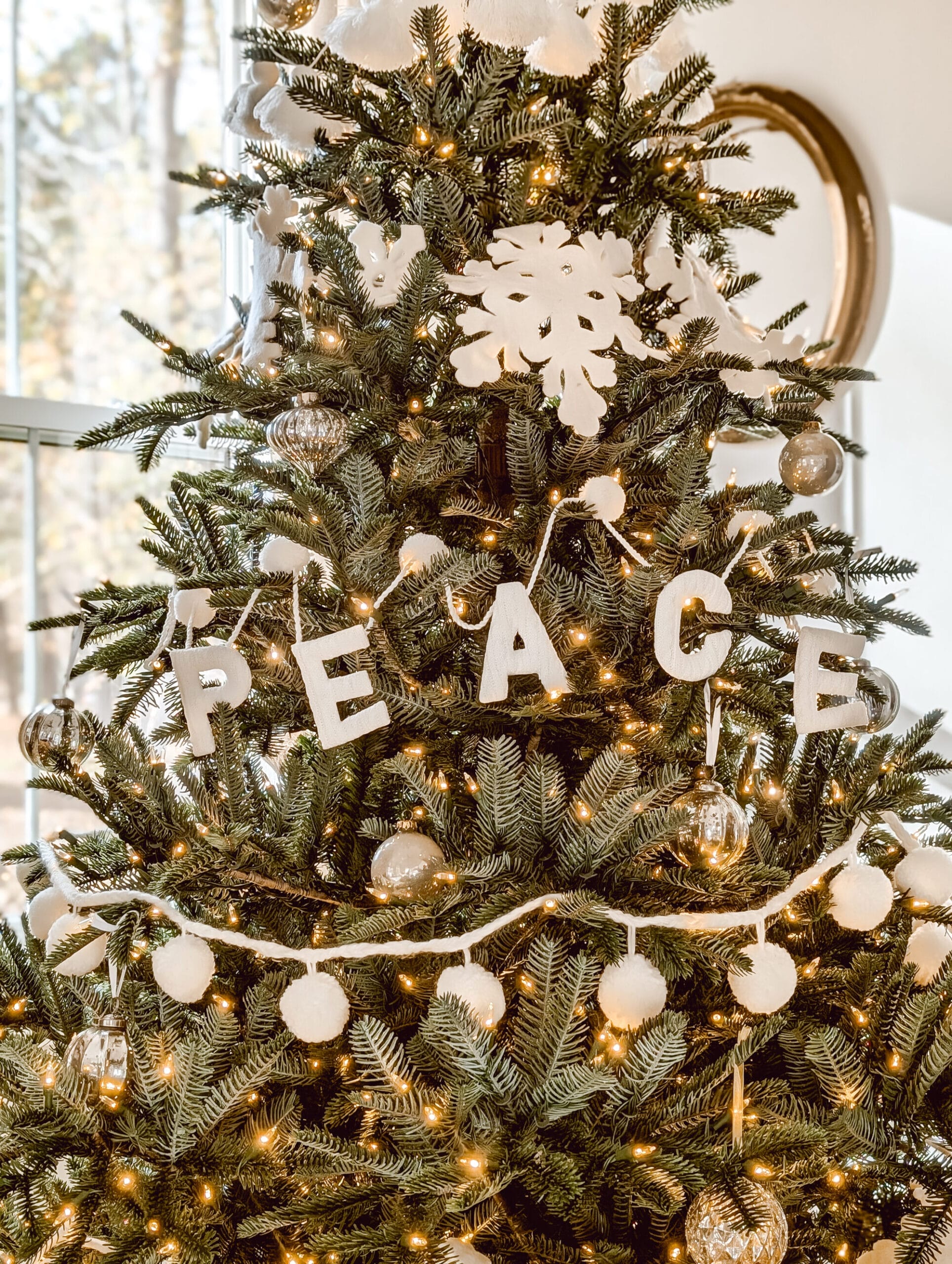 white garlands and mercury glass ornaments on the nordmann fir tree