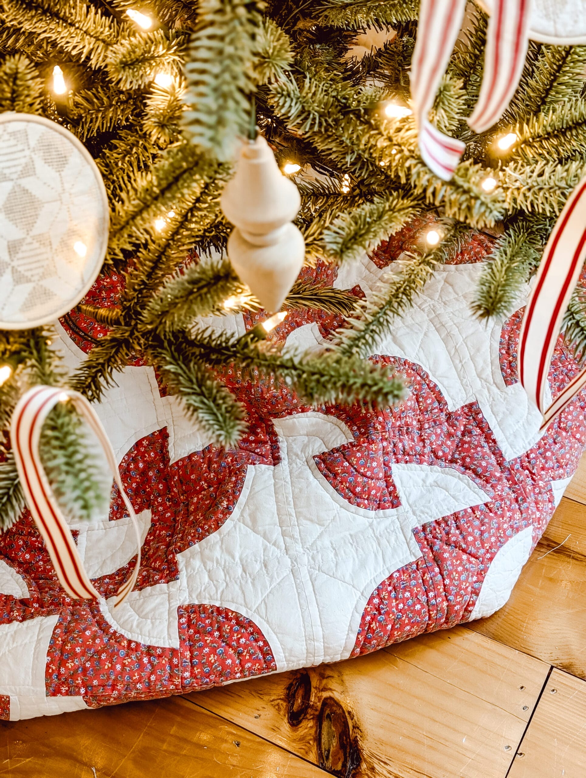 red and white drunkard's path quilt as a makeshift Christmas tree skirt