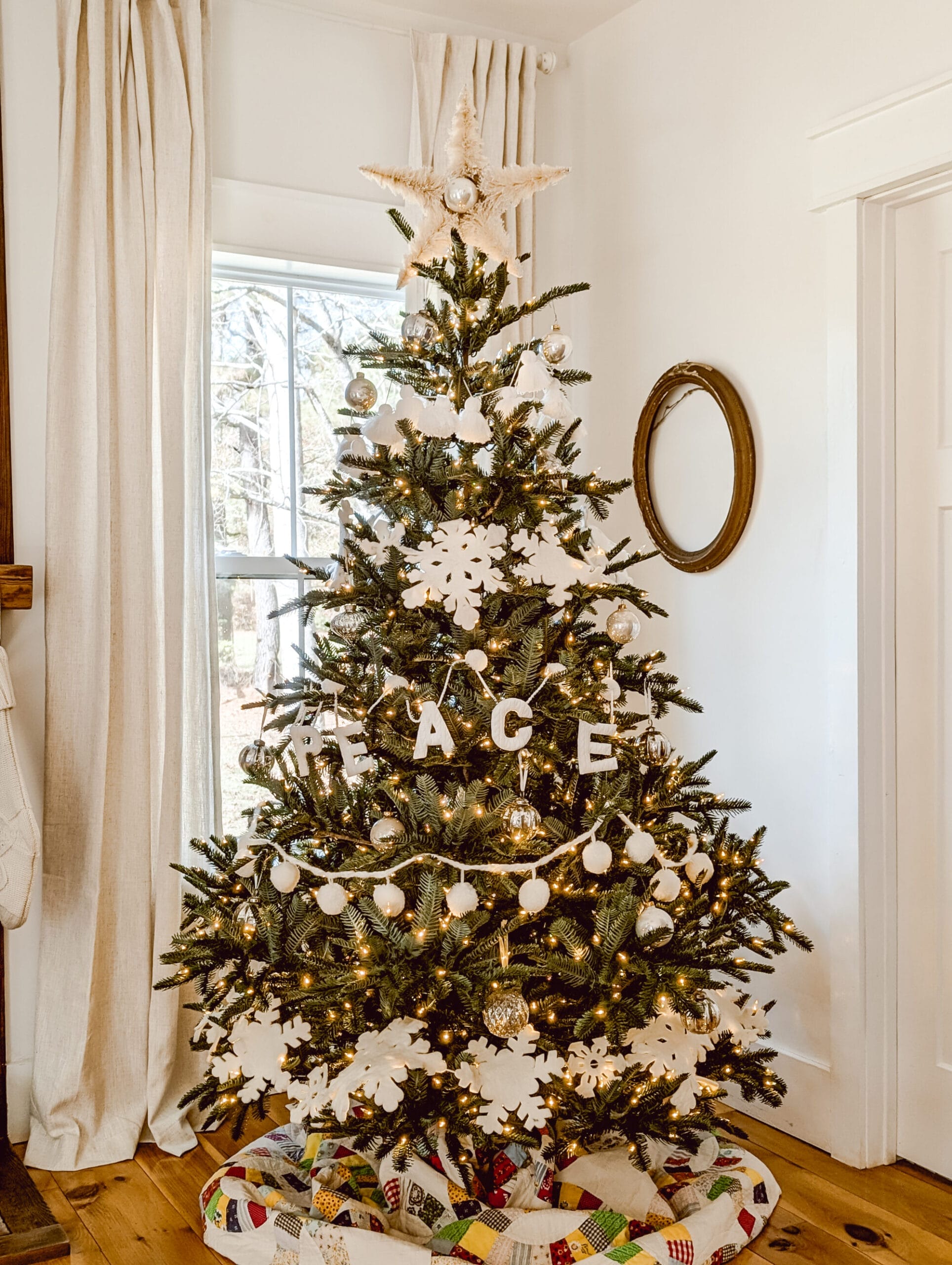 super realistic Nordmann fir Christmas tree from Balsam hill styled with white garlands, mercury glass ornaments and a DIY bottle brush star tree topper
