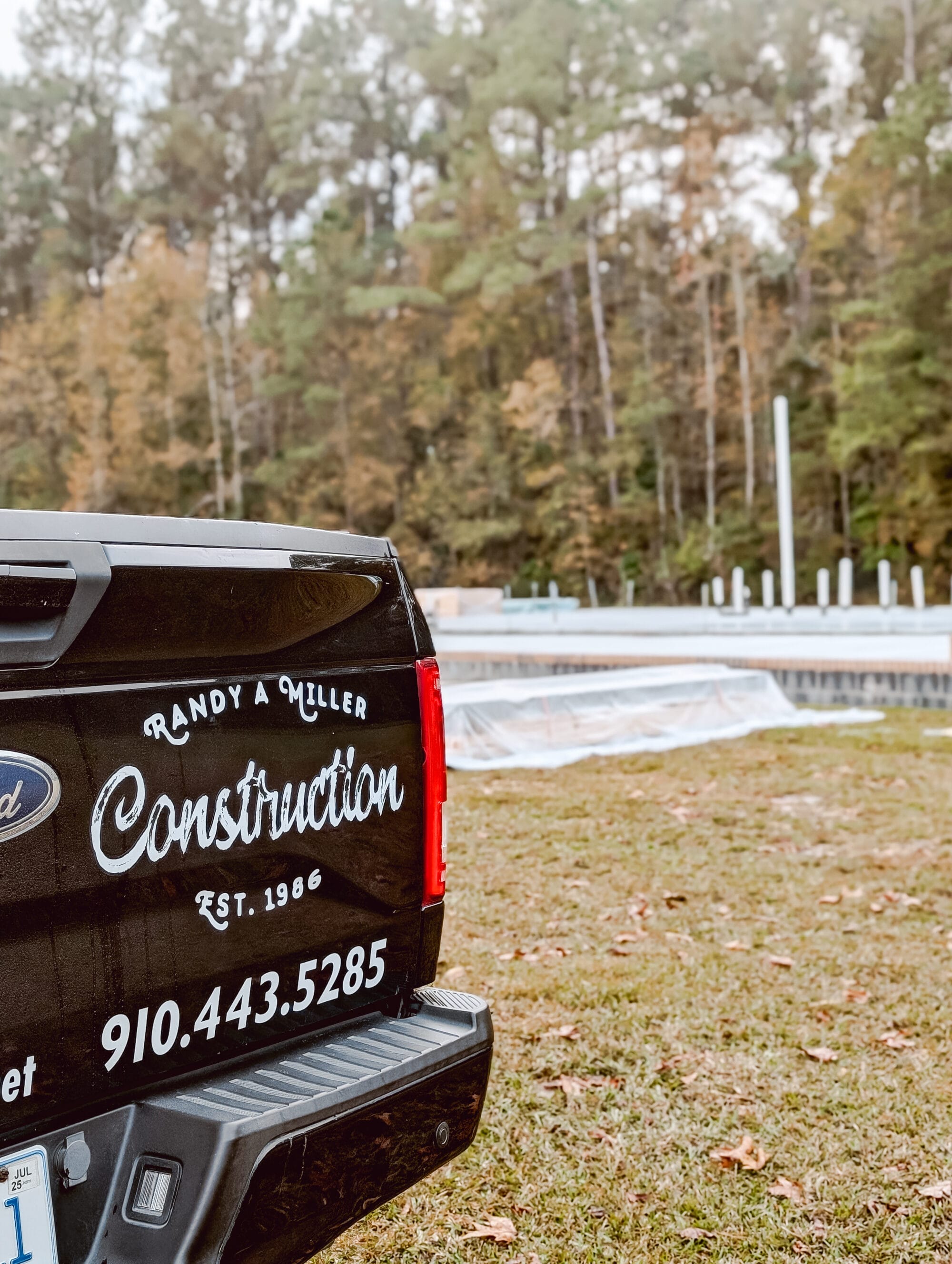 our builder's logo for Randy Miller Construction on the back of his truck at the construction site