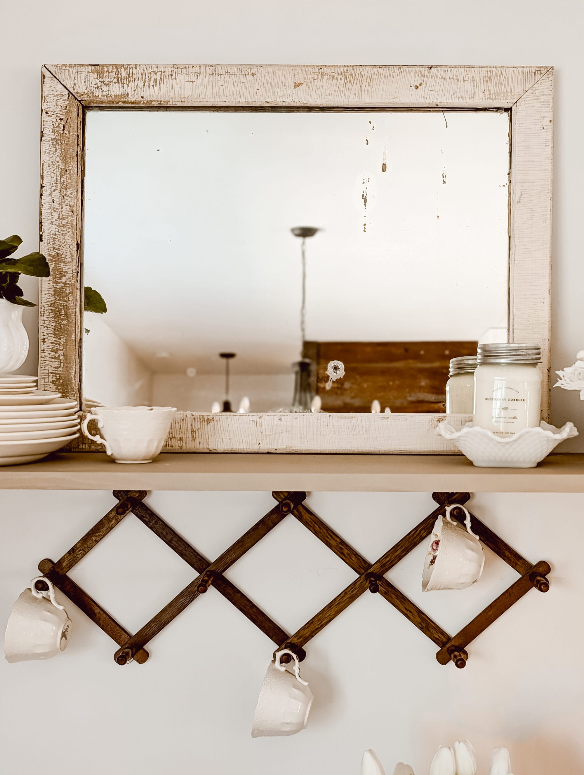 antique wood framed mirror with flaky chipping white paint