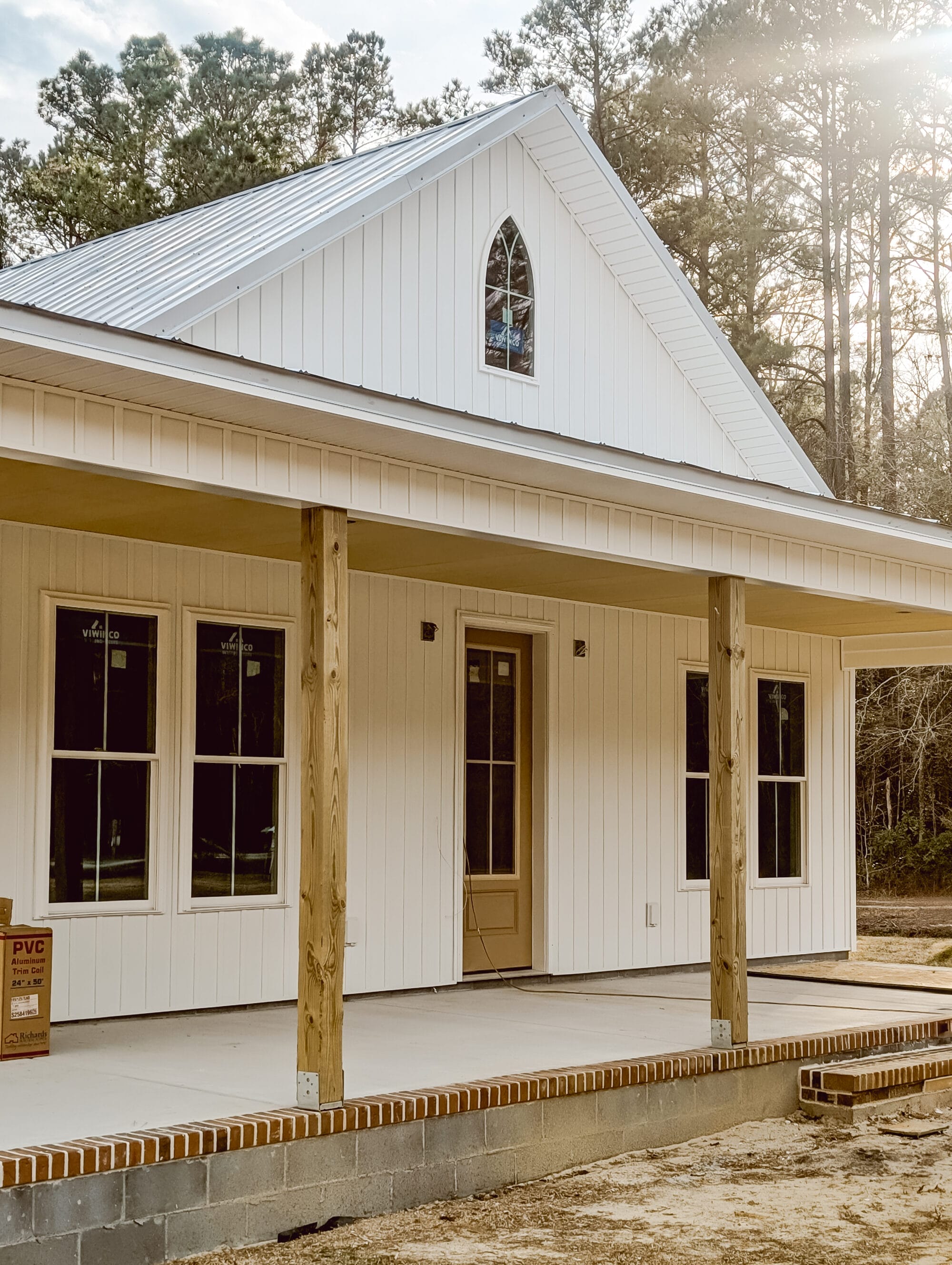 a pointed arch window over the wraparound porch of our new old cottage