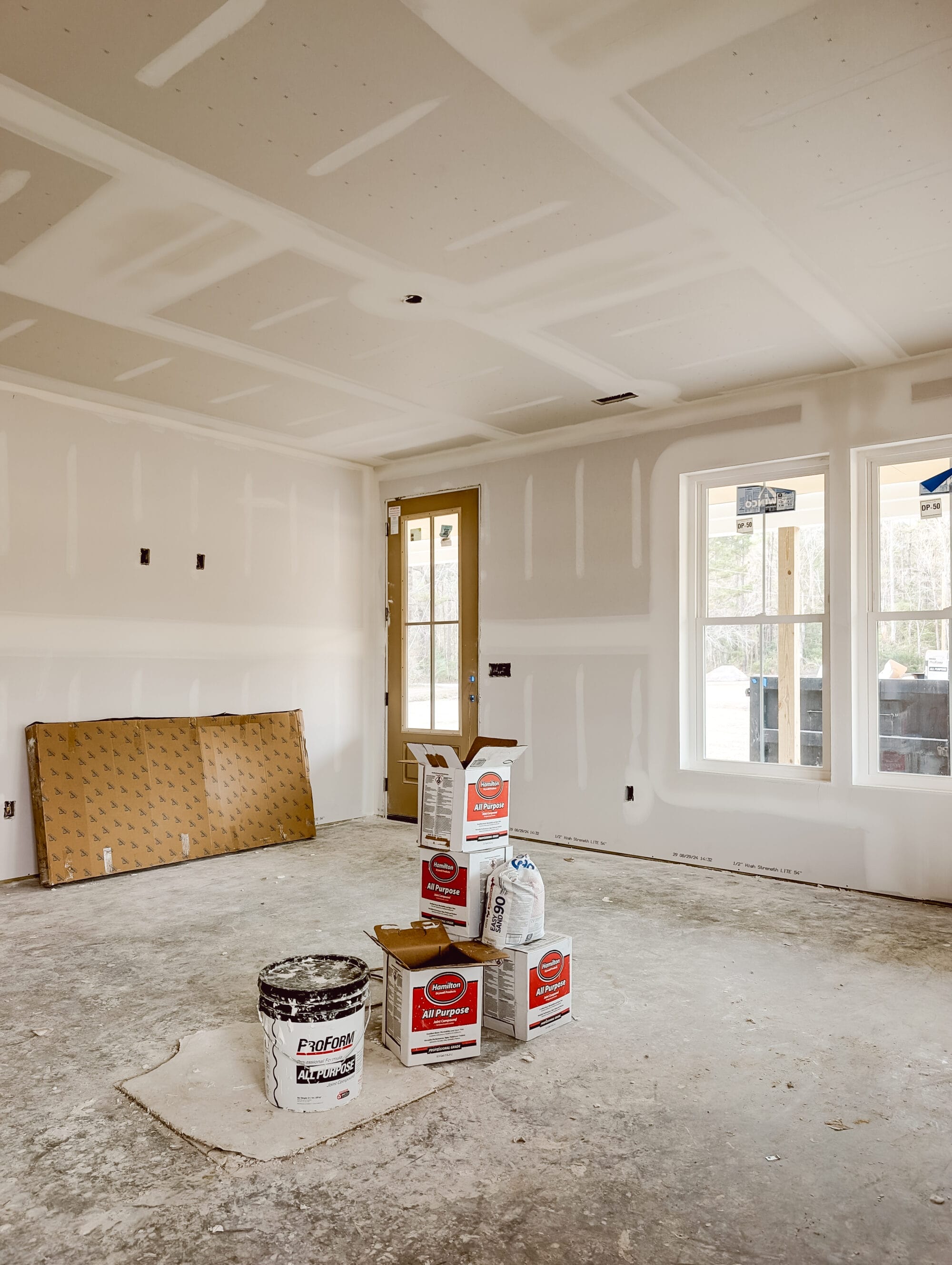 unfinished living room after drywall has been installed