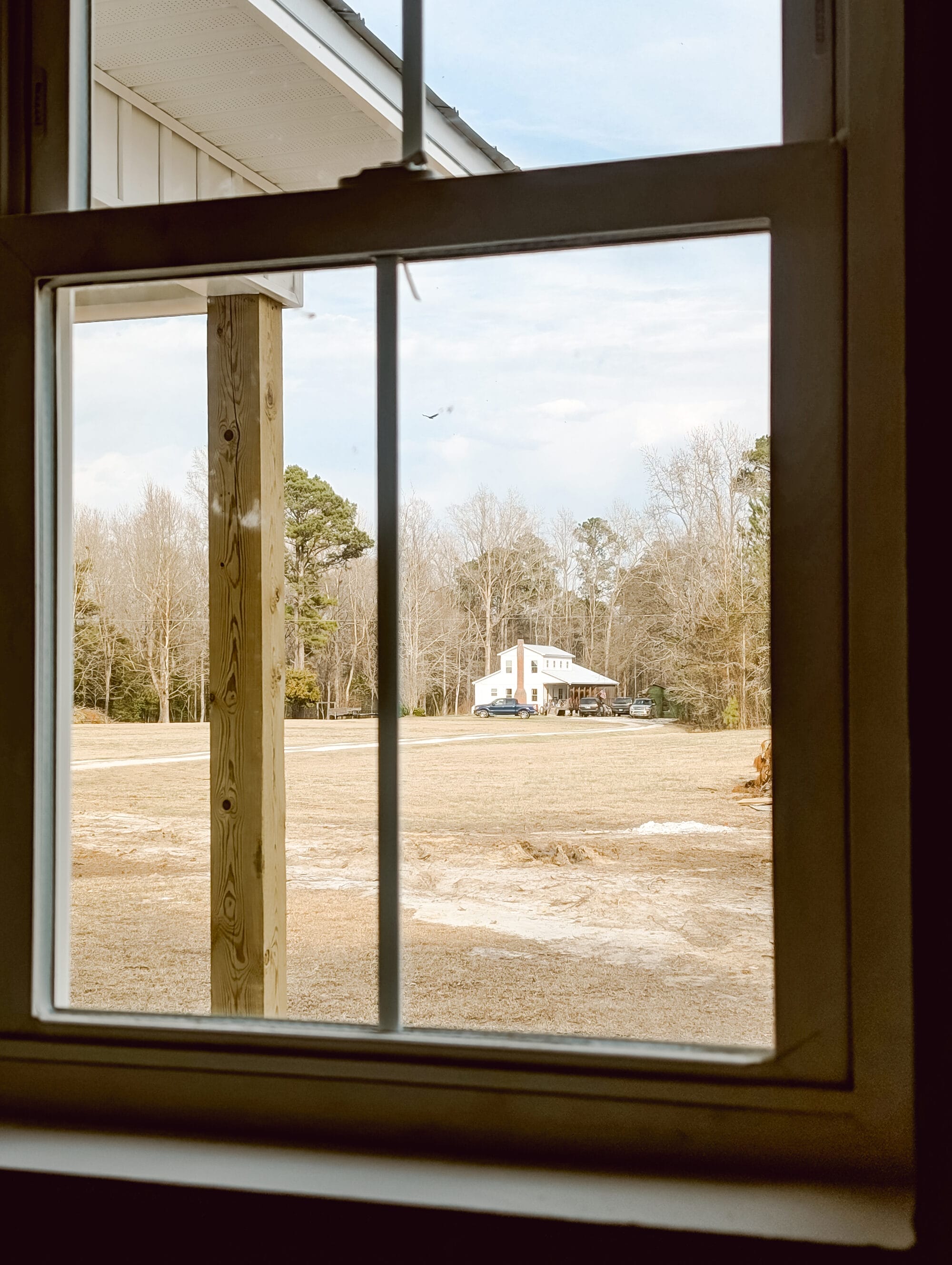 view of our old farmhouse through the cottage windows