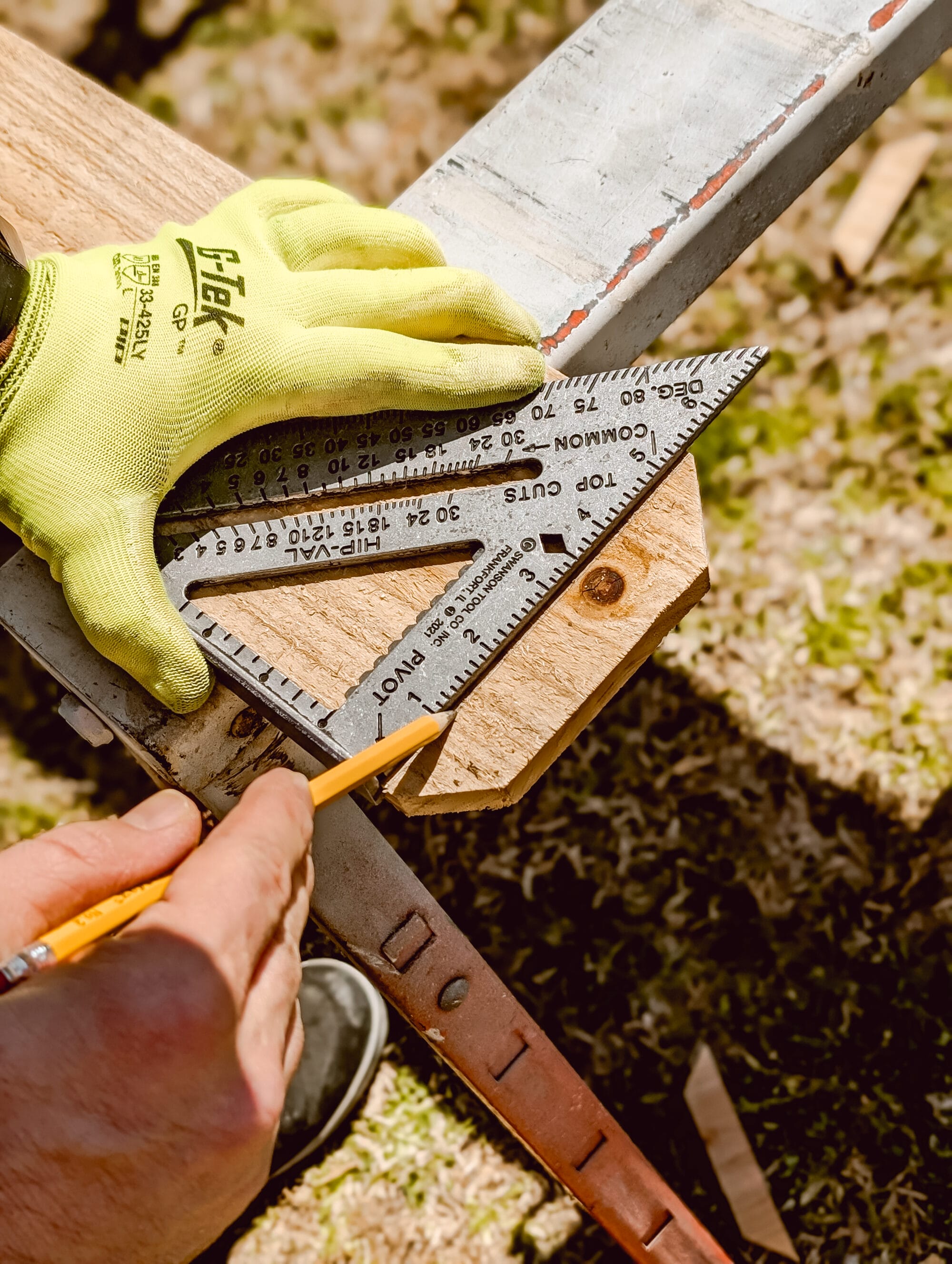 using a triangle to mark a line on a cedar fence picket before sawing