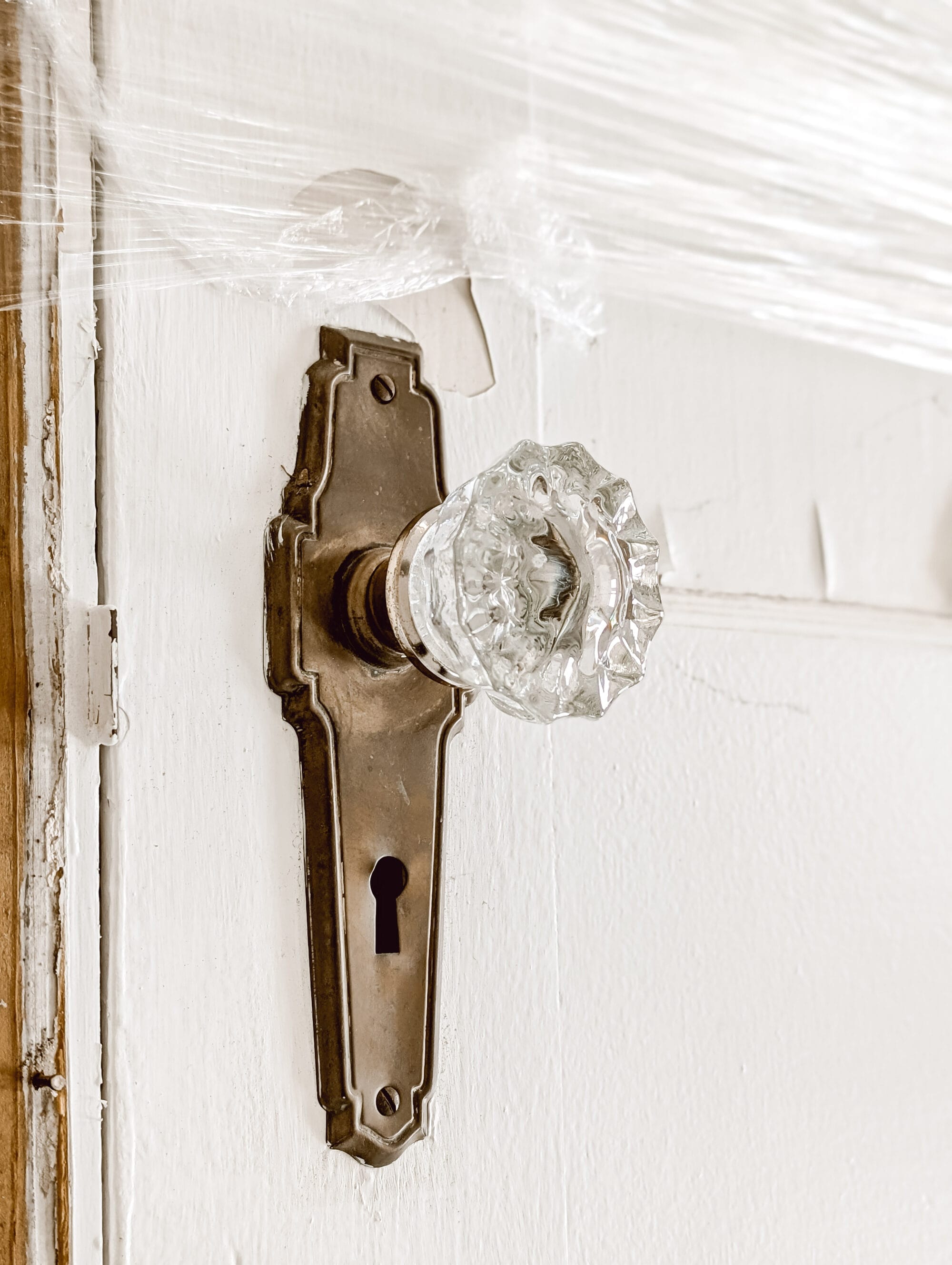 antique brass and crystal door knob on an old door