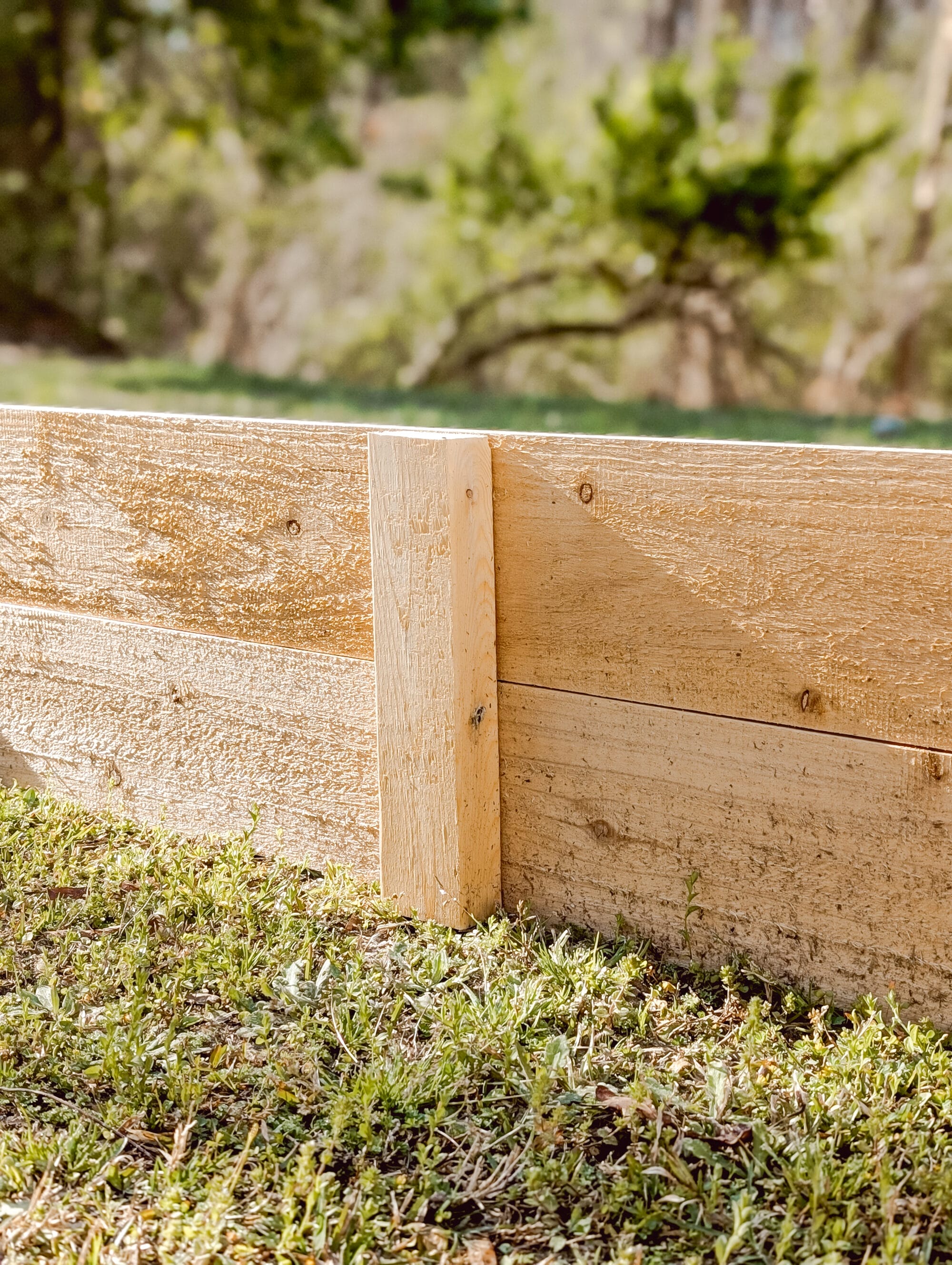 2 x 4 support board inside a wood raised garden bed