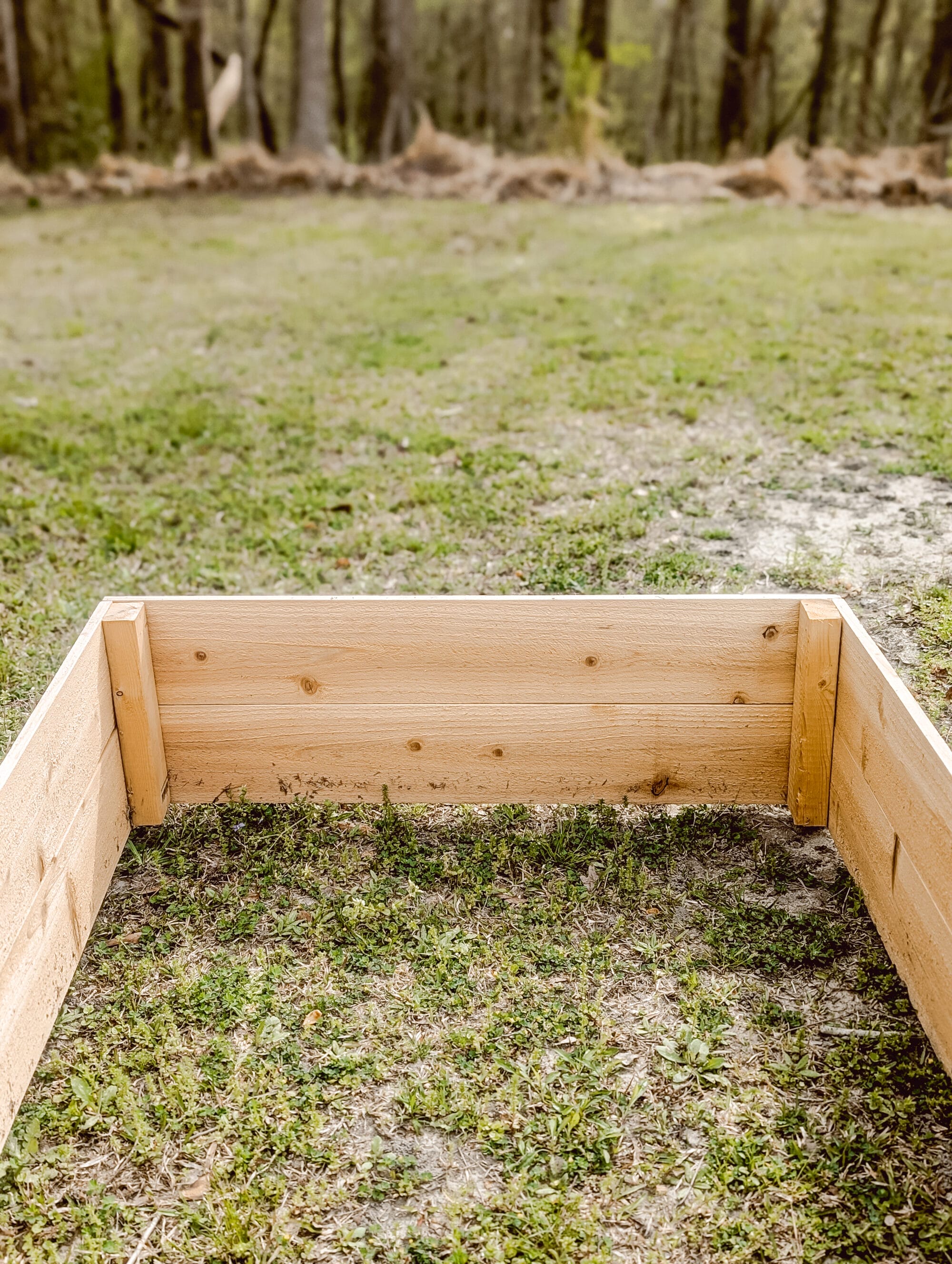 2 x 4 support boards inside a wood raised garden bed