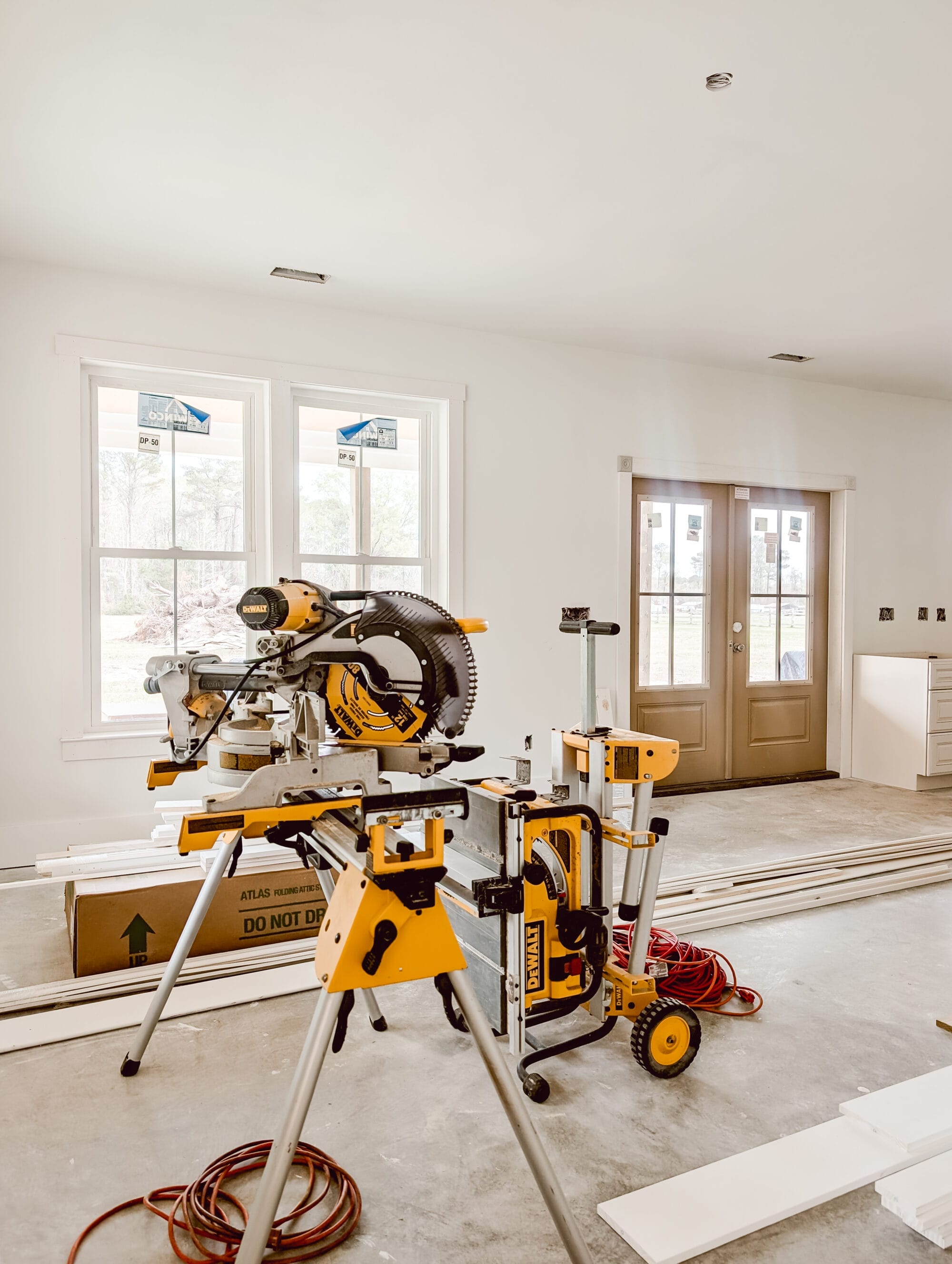 views inside our unfinished living room in our new old cottage with construction tools and supplies