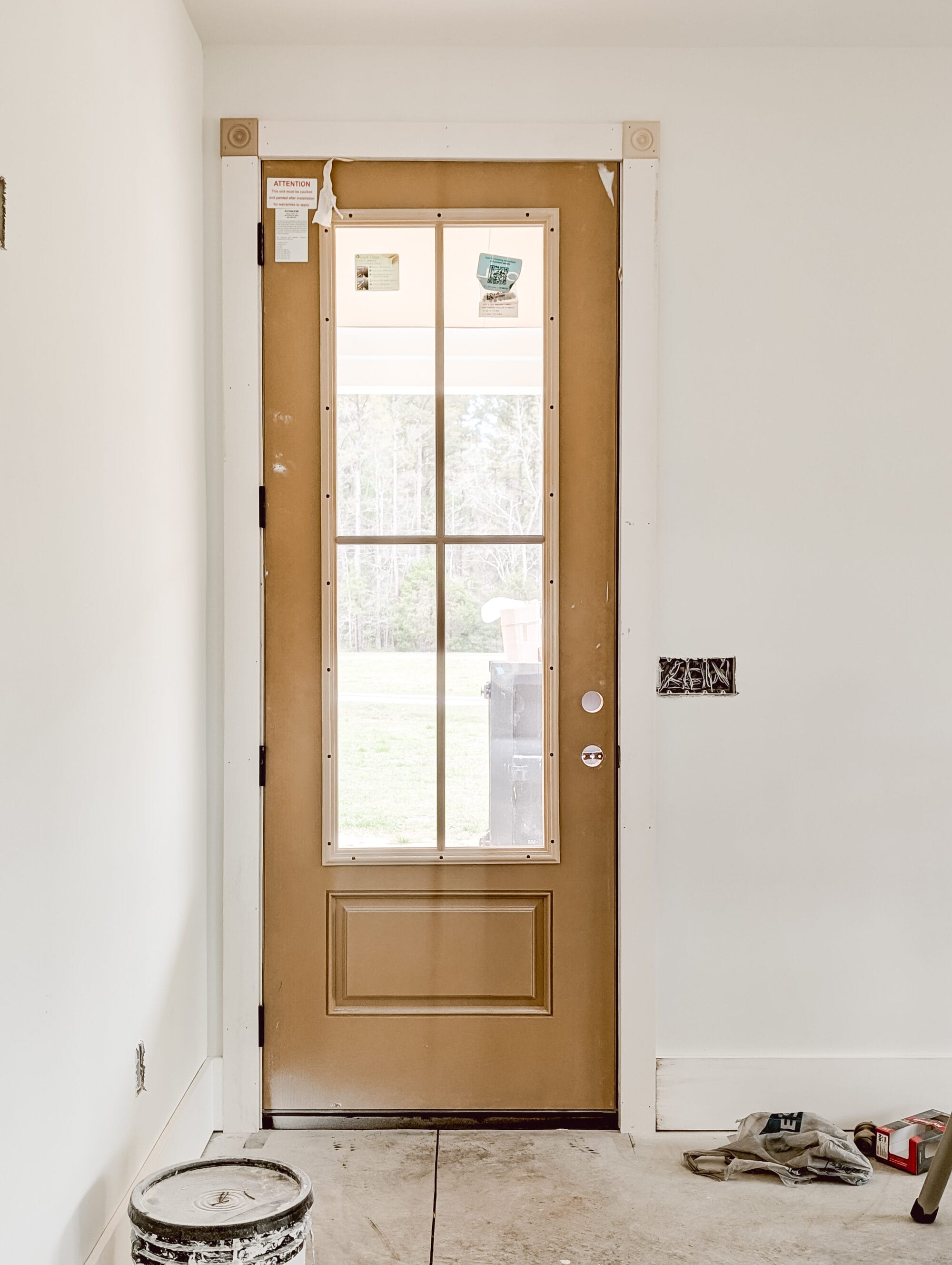 unpainted 3/4 light front door during construction