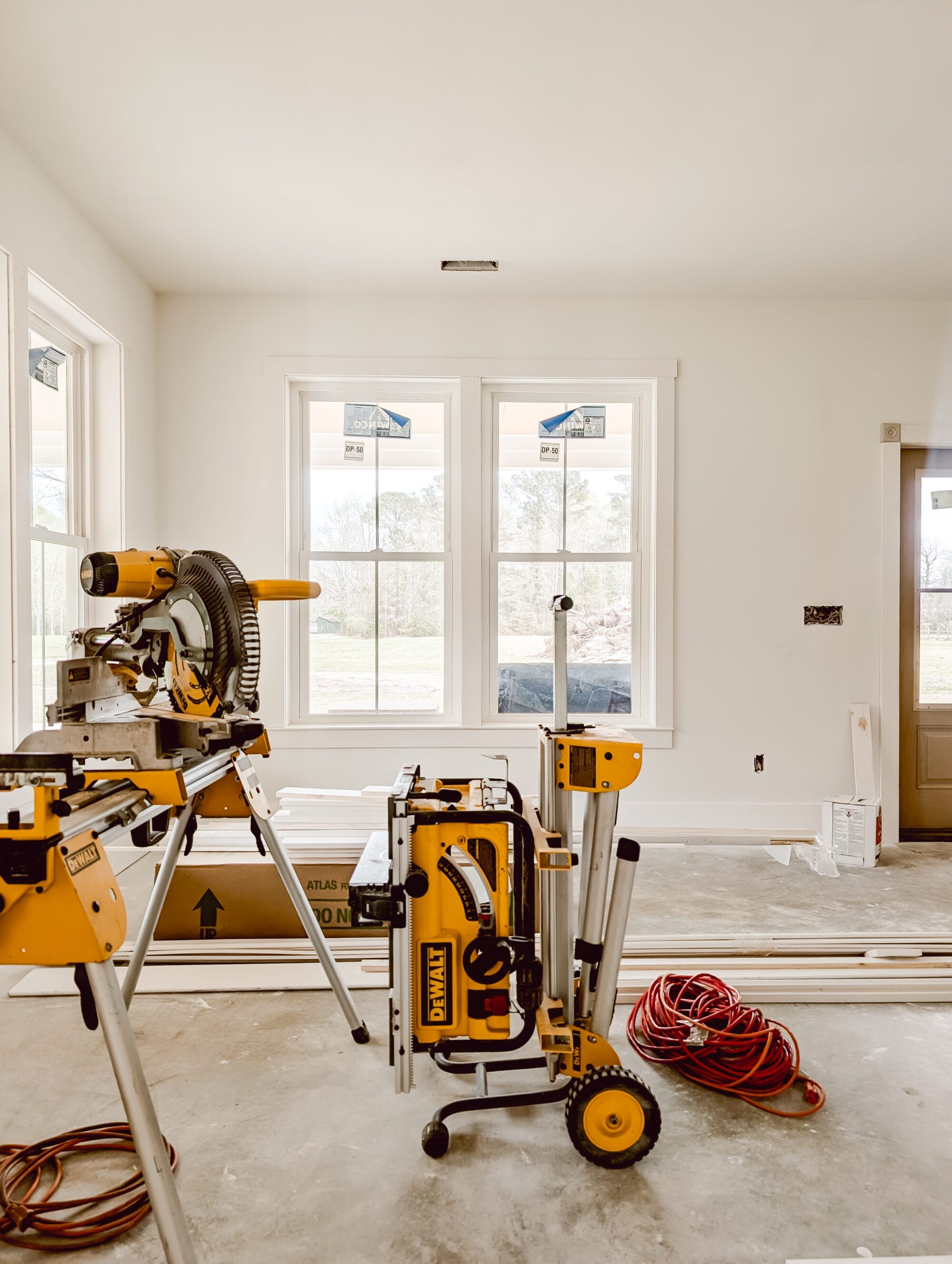 views inside our unfinished living room in our new old cottage with construction tools and supplies