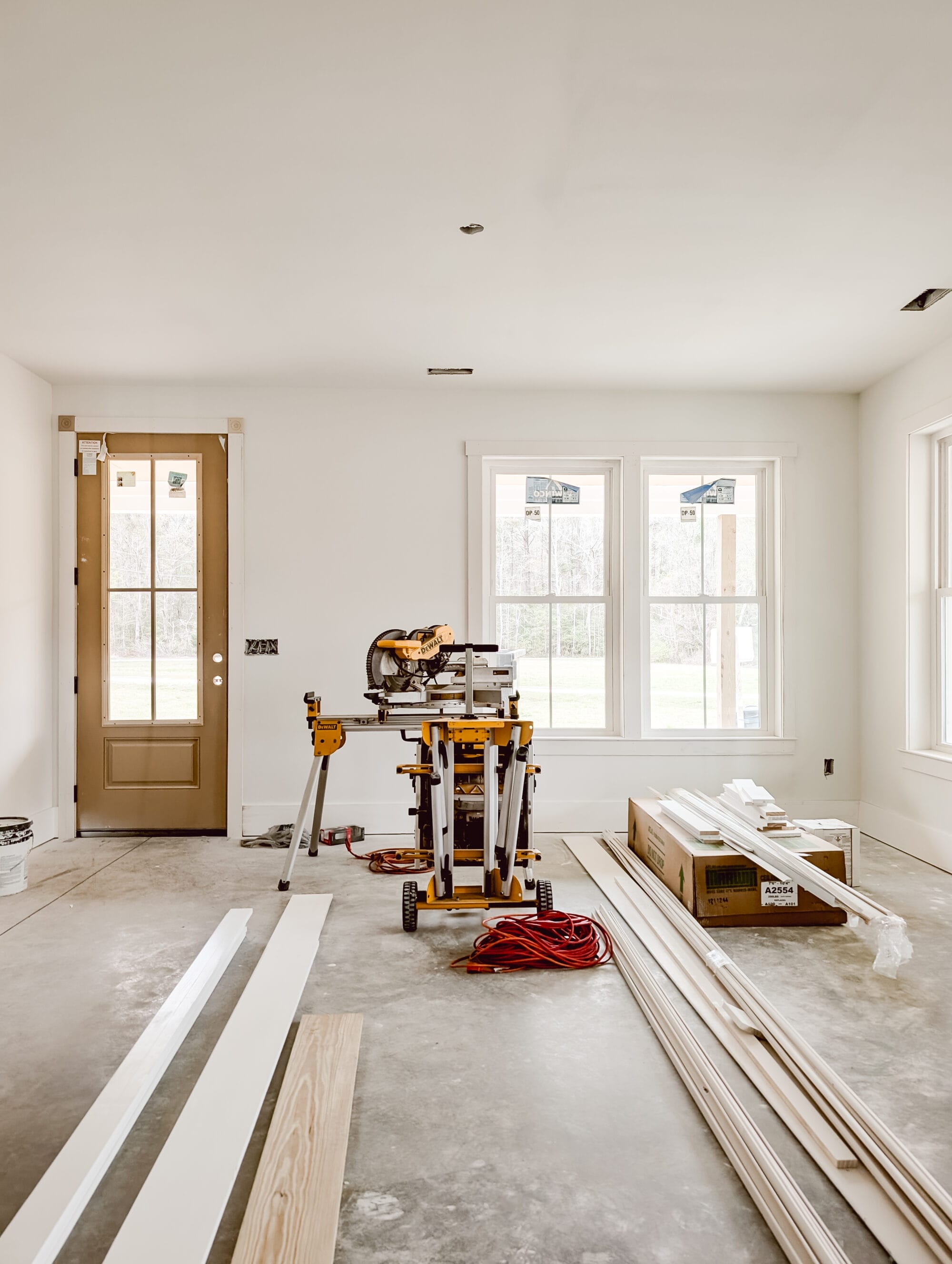 unfinished living room inside our 2 bedroom, 2 bath new old cottage with construction tools and supplies