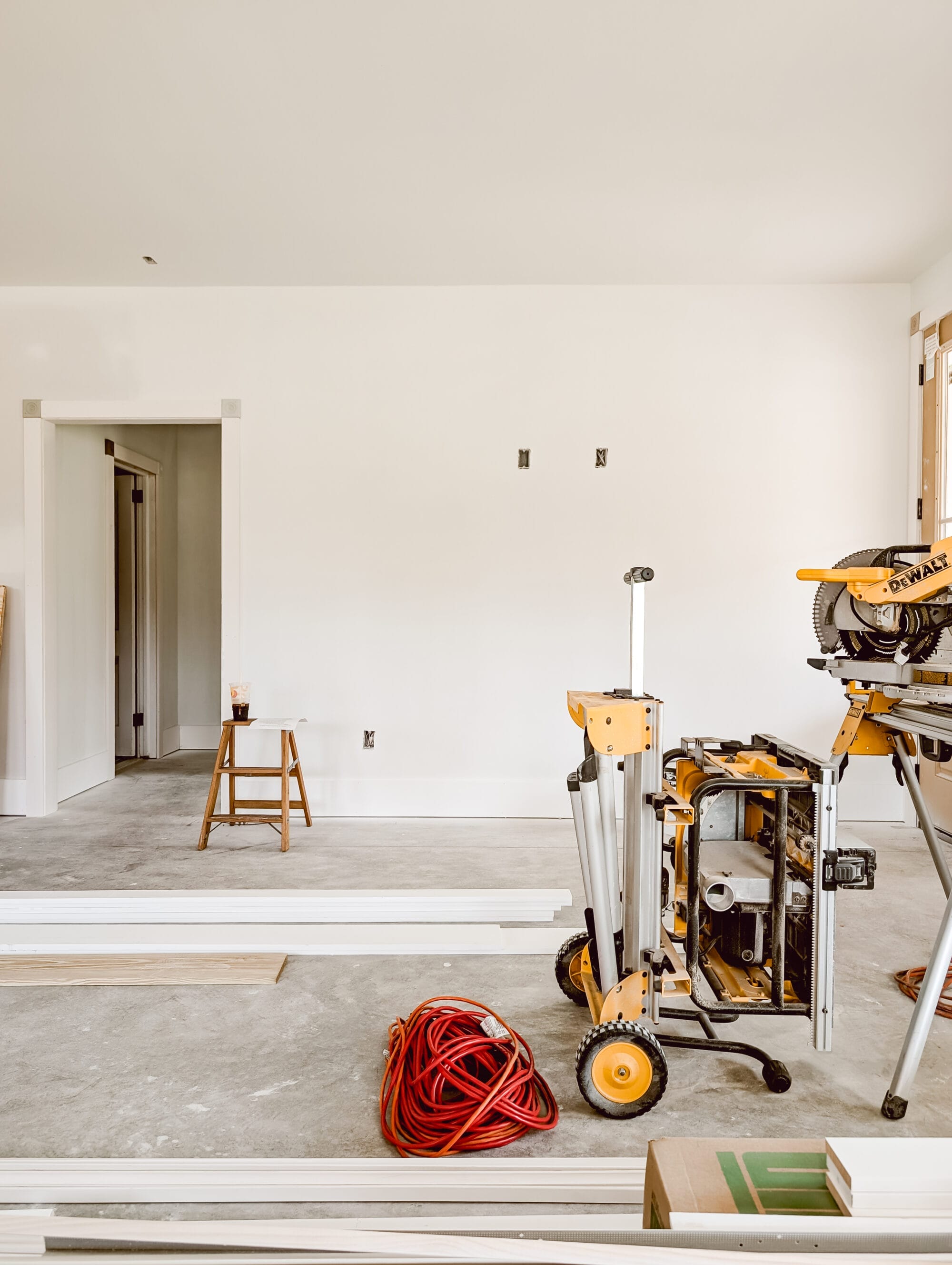 unfinished living room inside our 2 bedroom, 2 bath new old cottage with construction tools and supplies