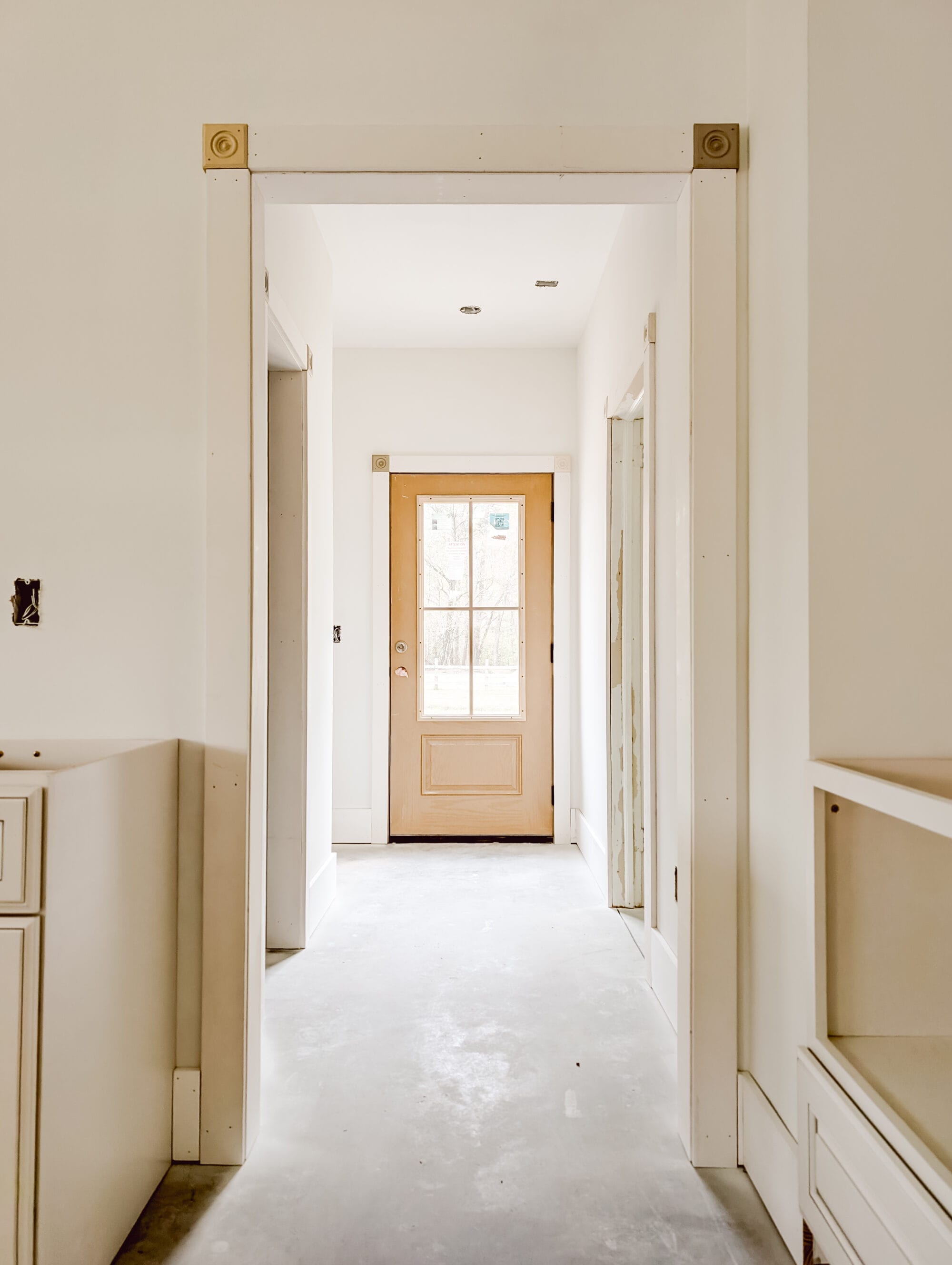 unpainted back door and unfinished rear entry hall of our new old cottage