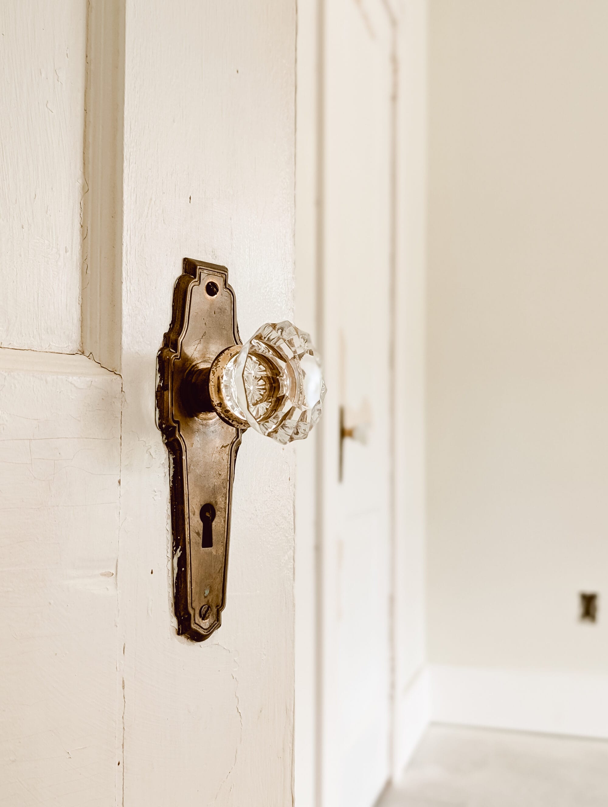 antique brass and crystal knob on an antique door salvaged from a 1920's home in Charlotte, NC