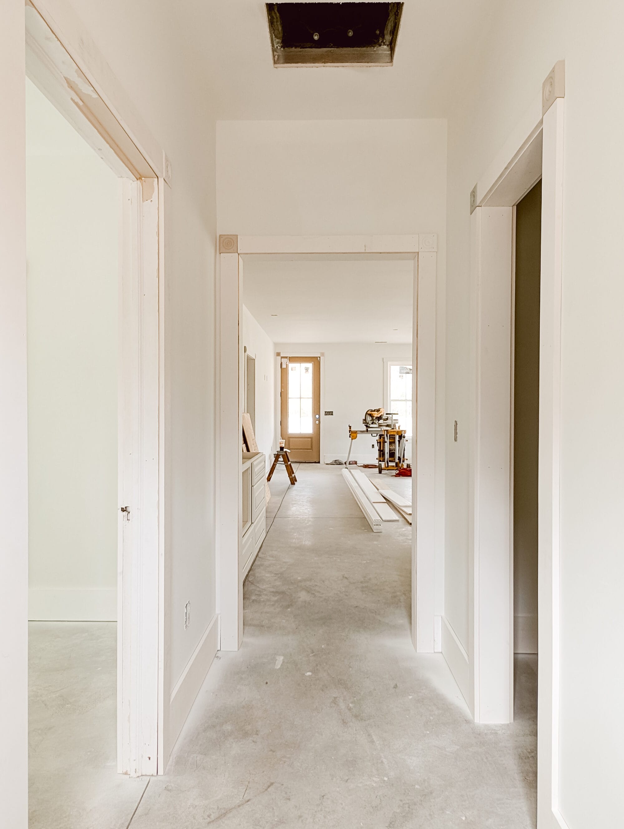 looking from the back entry down the hallway and through to the front door