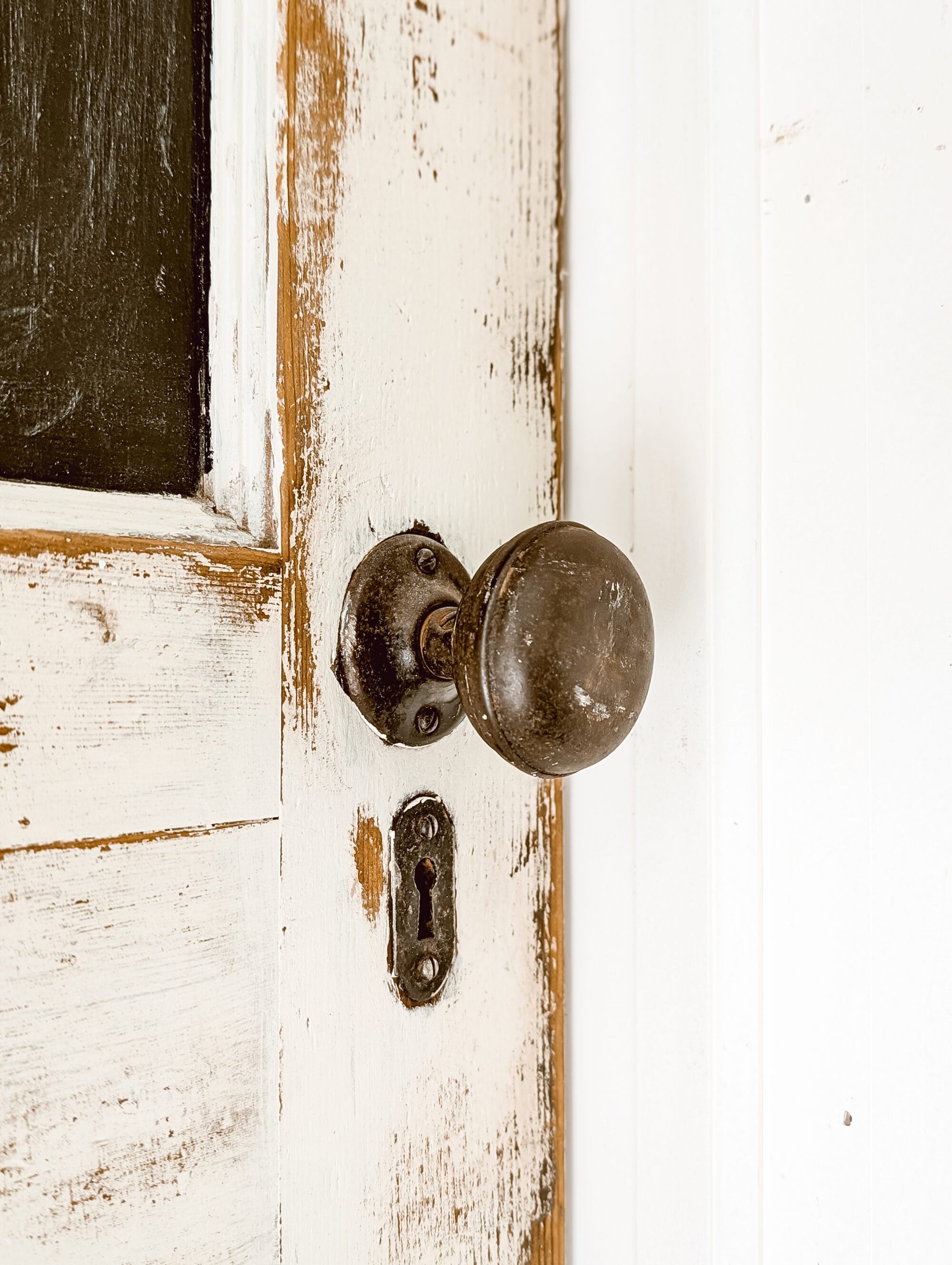 old timey antique door knob with patina and a separate keyhole
