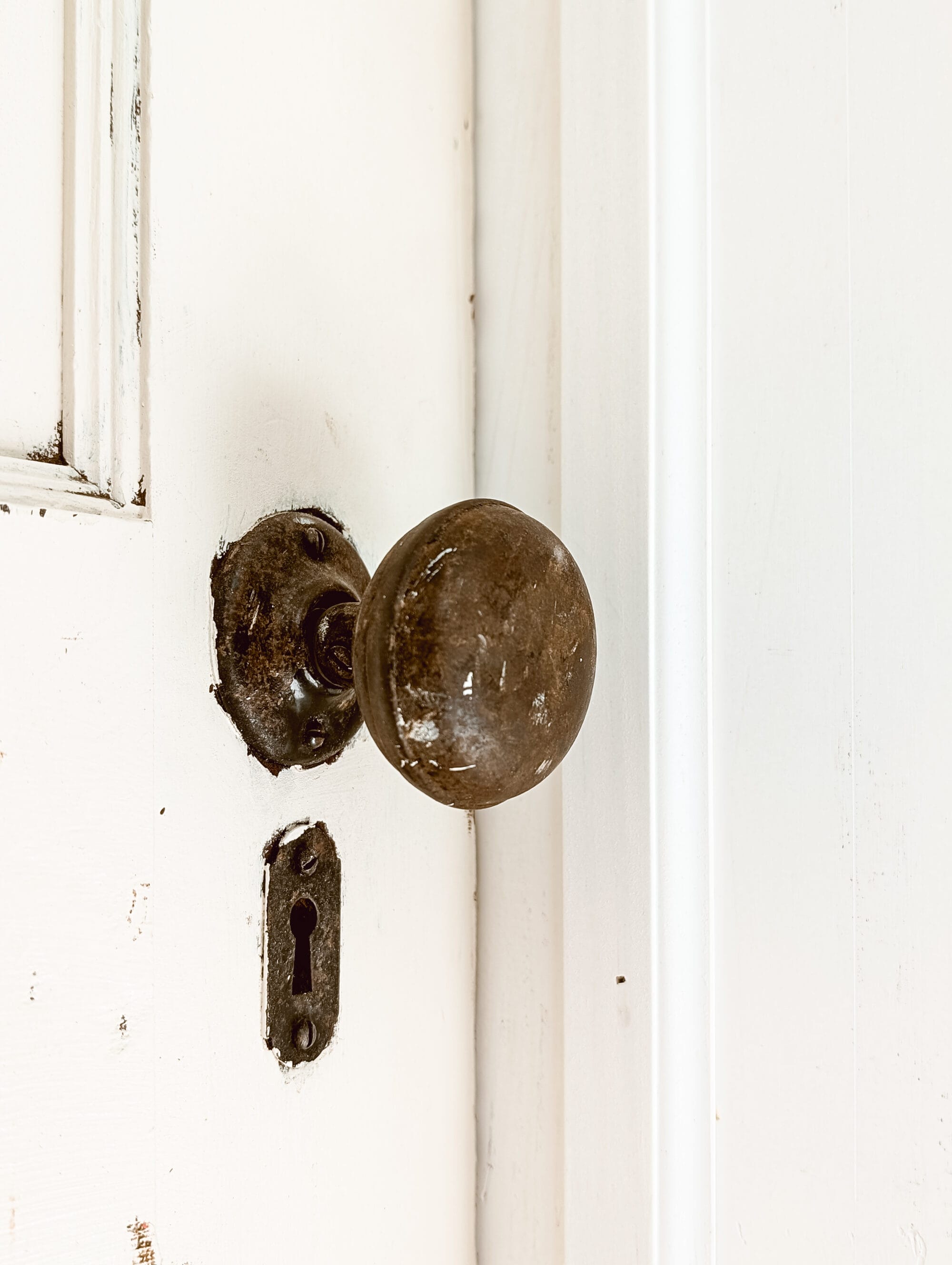 old timey antique door knob with patina and a separate keyhole