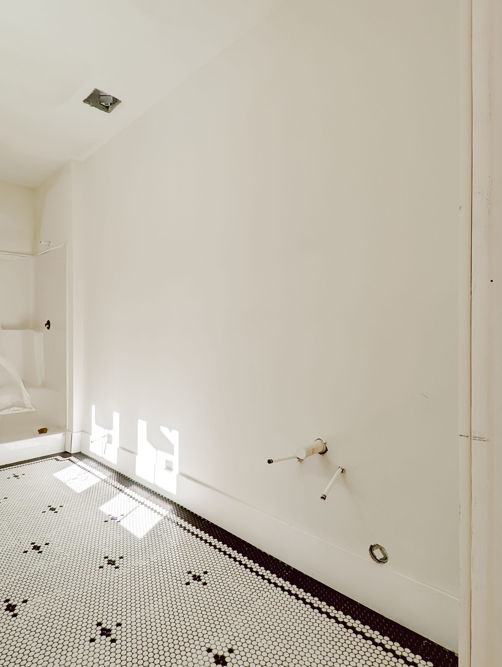 building a new old cottage bathroom with vintage black and white penny tiles