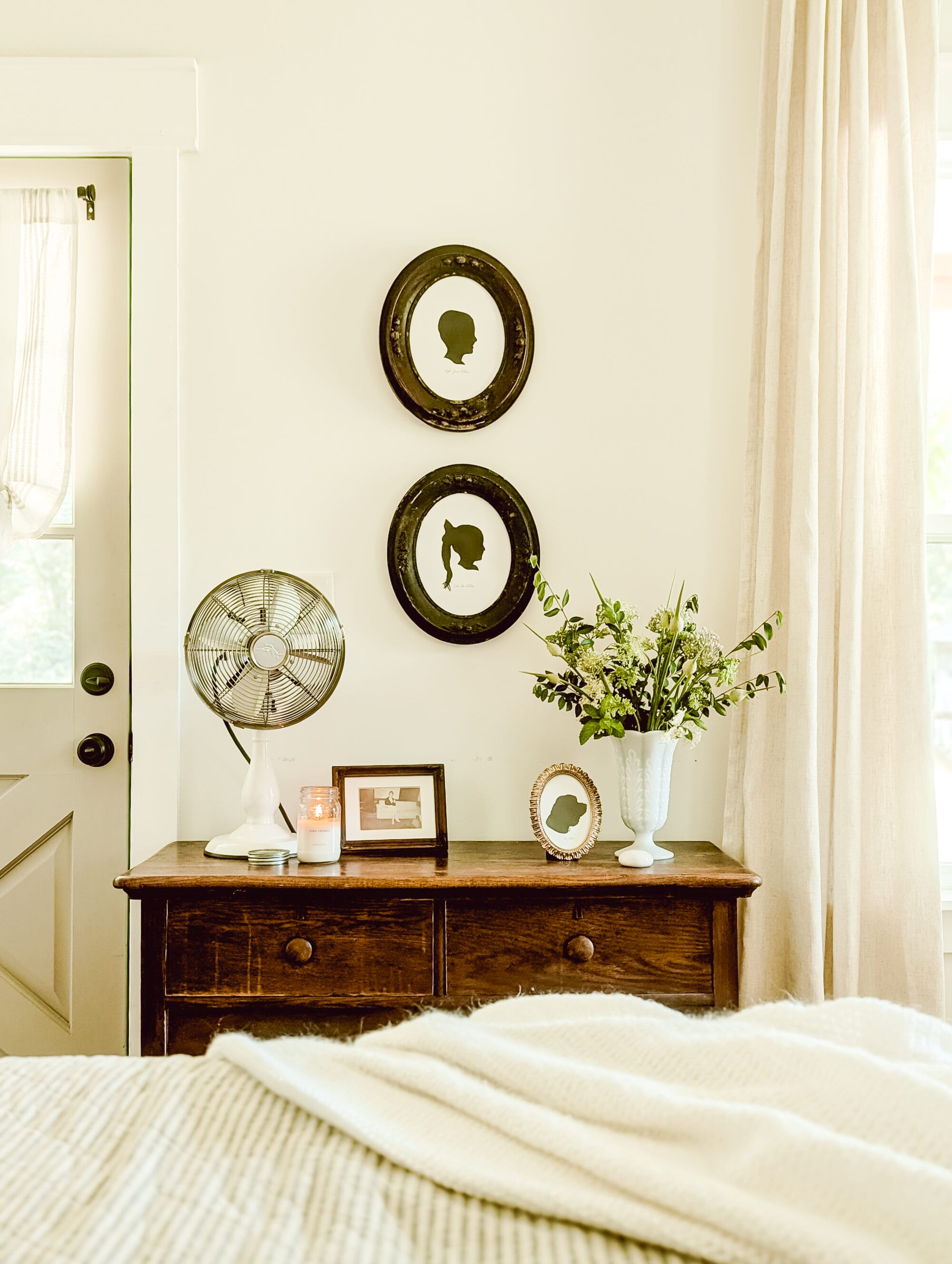DIY silhouette portraits of children in antique oval frames hung on the wall 