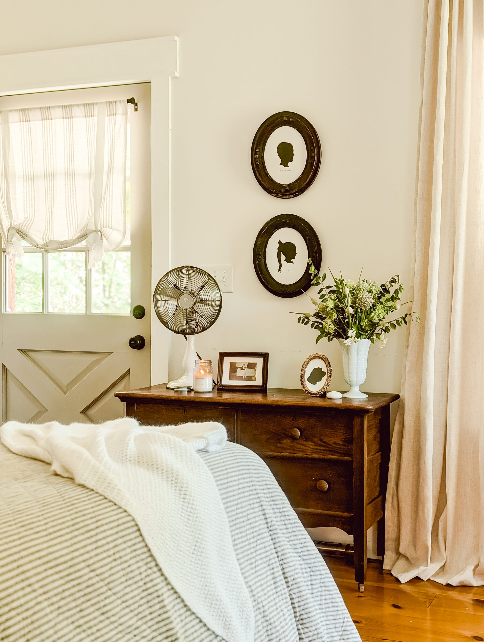 vintage cottage farmhouse style bedroom with heirloom silhouette portraits on the walls