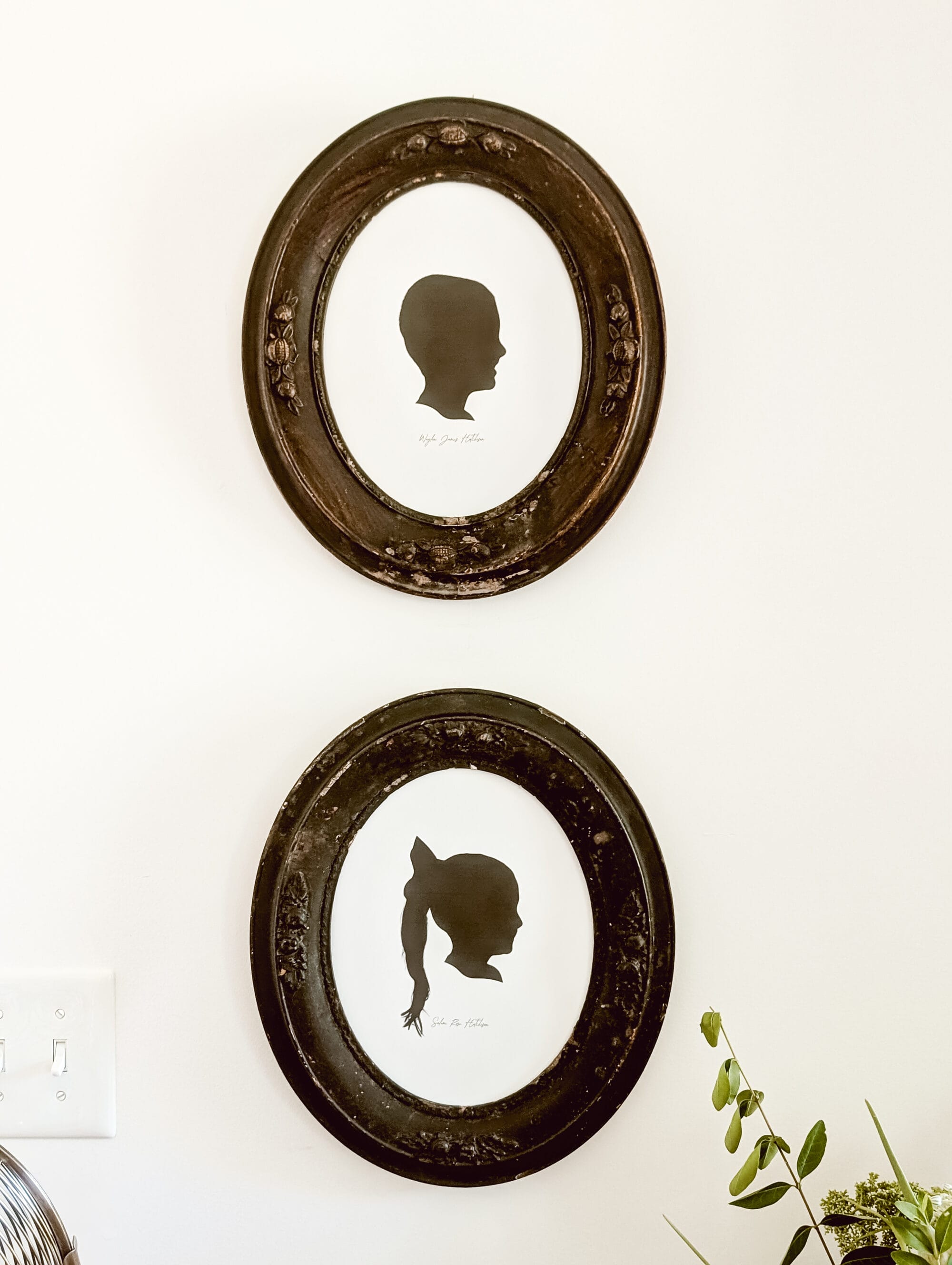 antique oval frames with black and white silhouette portrait of a little boy and a little girl