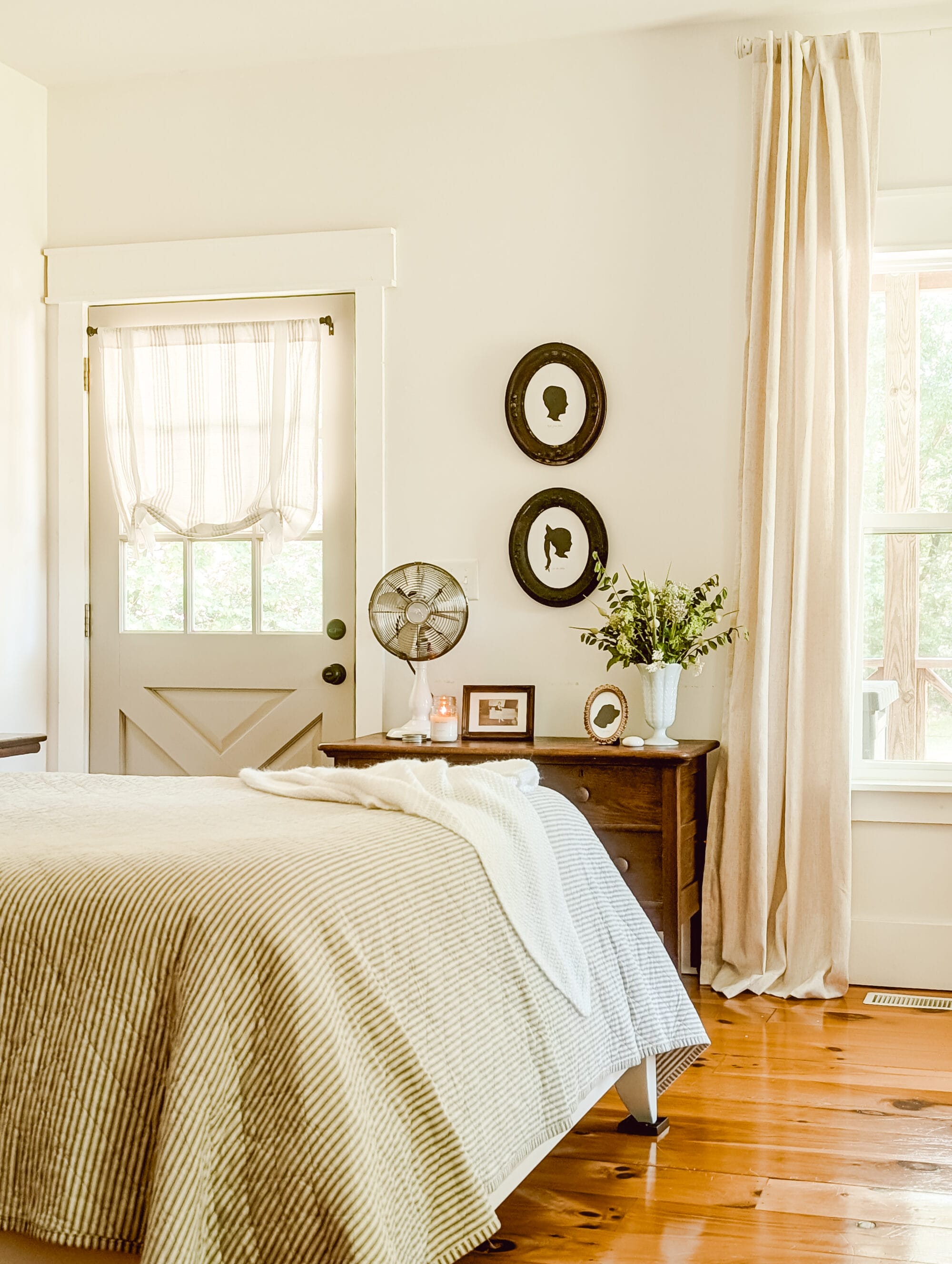 vintage cottage farmhouse style bedroom with heirloom silhouette portraits on the walls