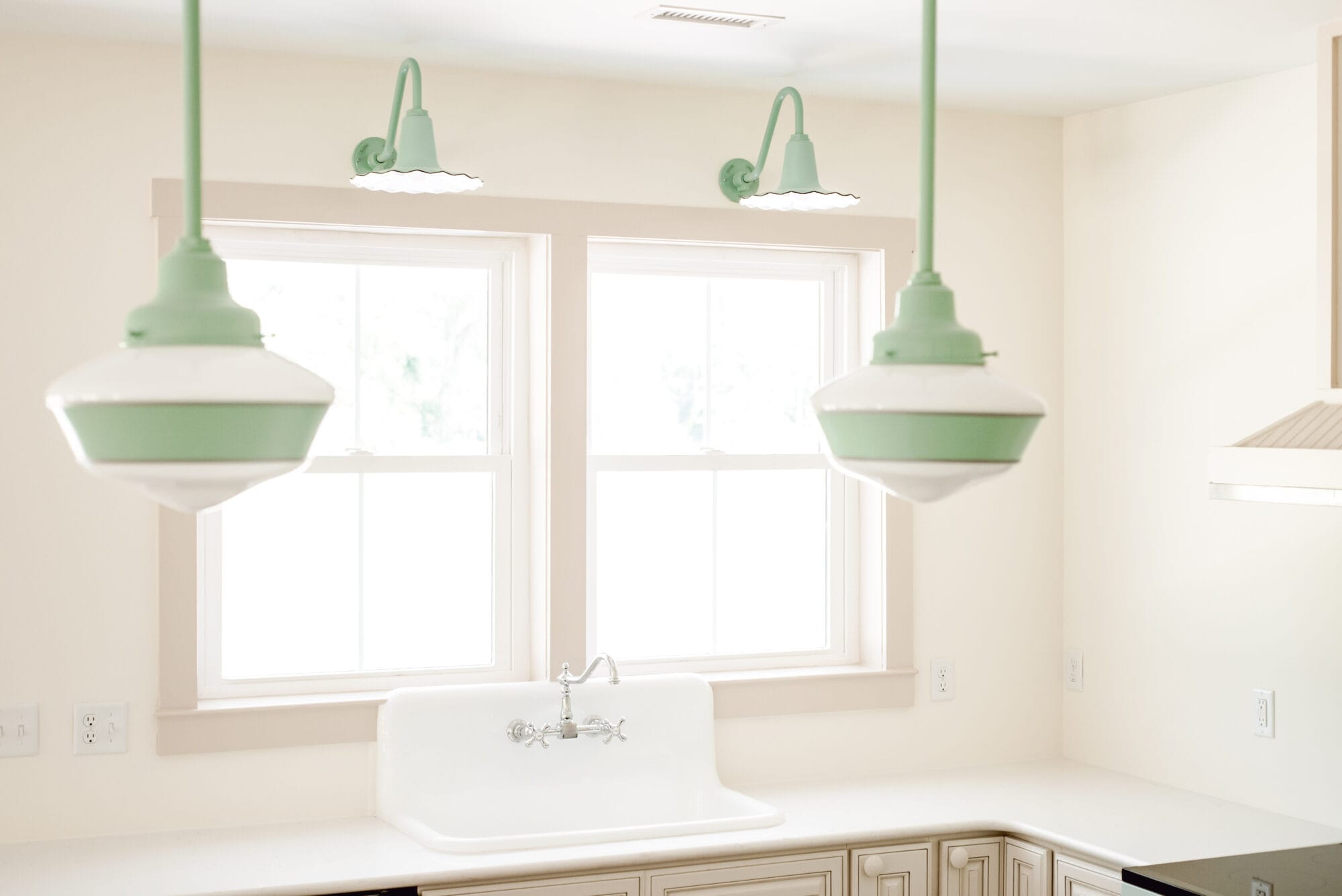 jadeite green seaside sconce lights from Barn Light Electric over the kitchen sink window