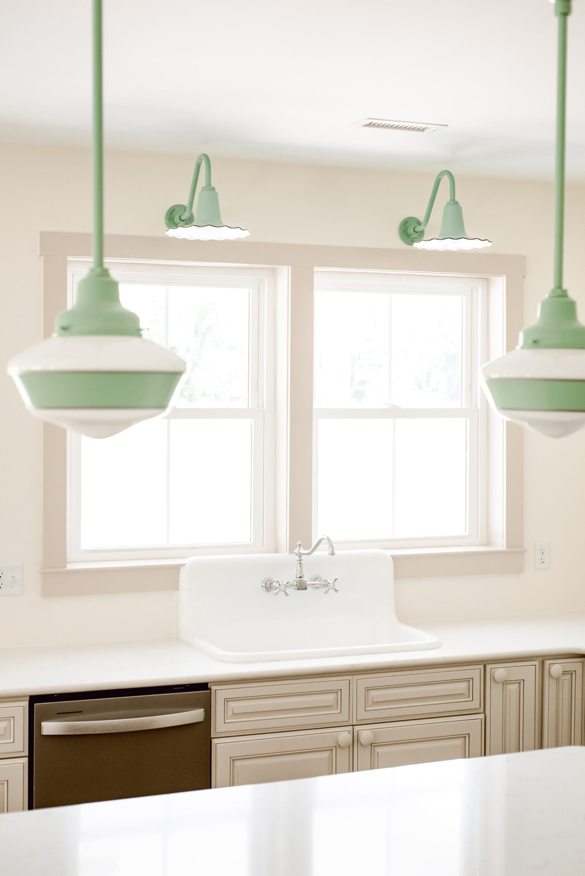 Barn Light Electric's playful seaside sconces over the kitchen sink in our new old cottage kitchen