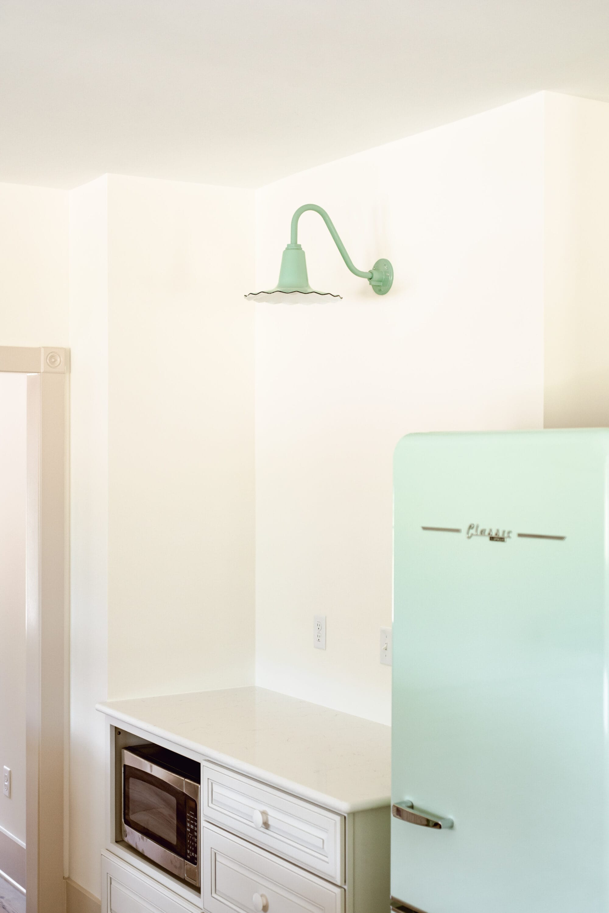 jadeite green seaside sconce light from Barn Light Electric by the fridge wall