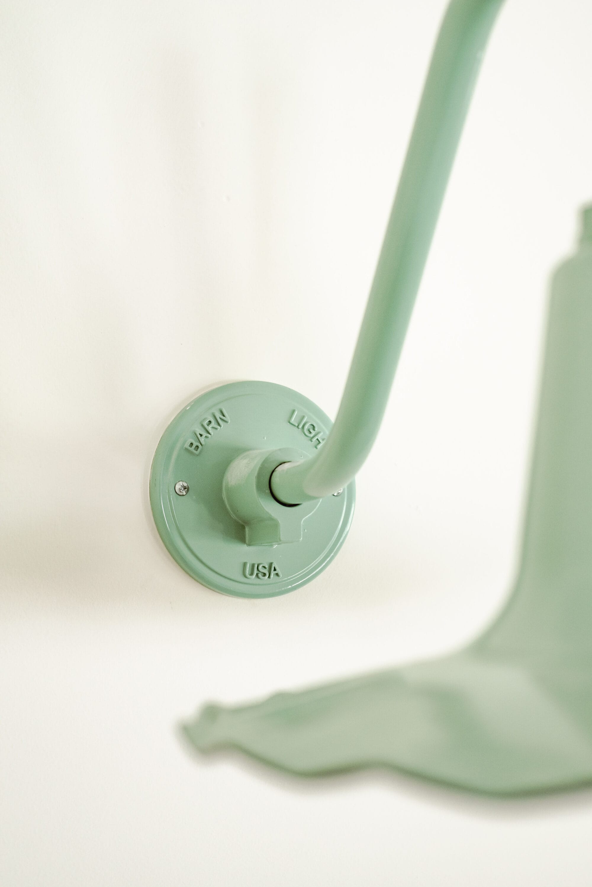 detail of "Barn Light USA" on the wall plate of a sconce light