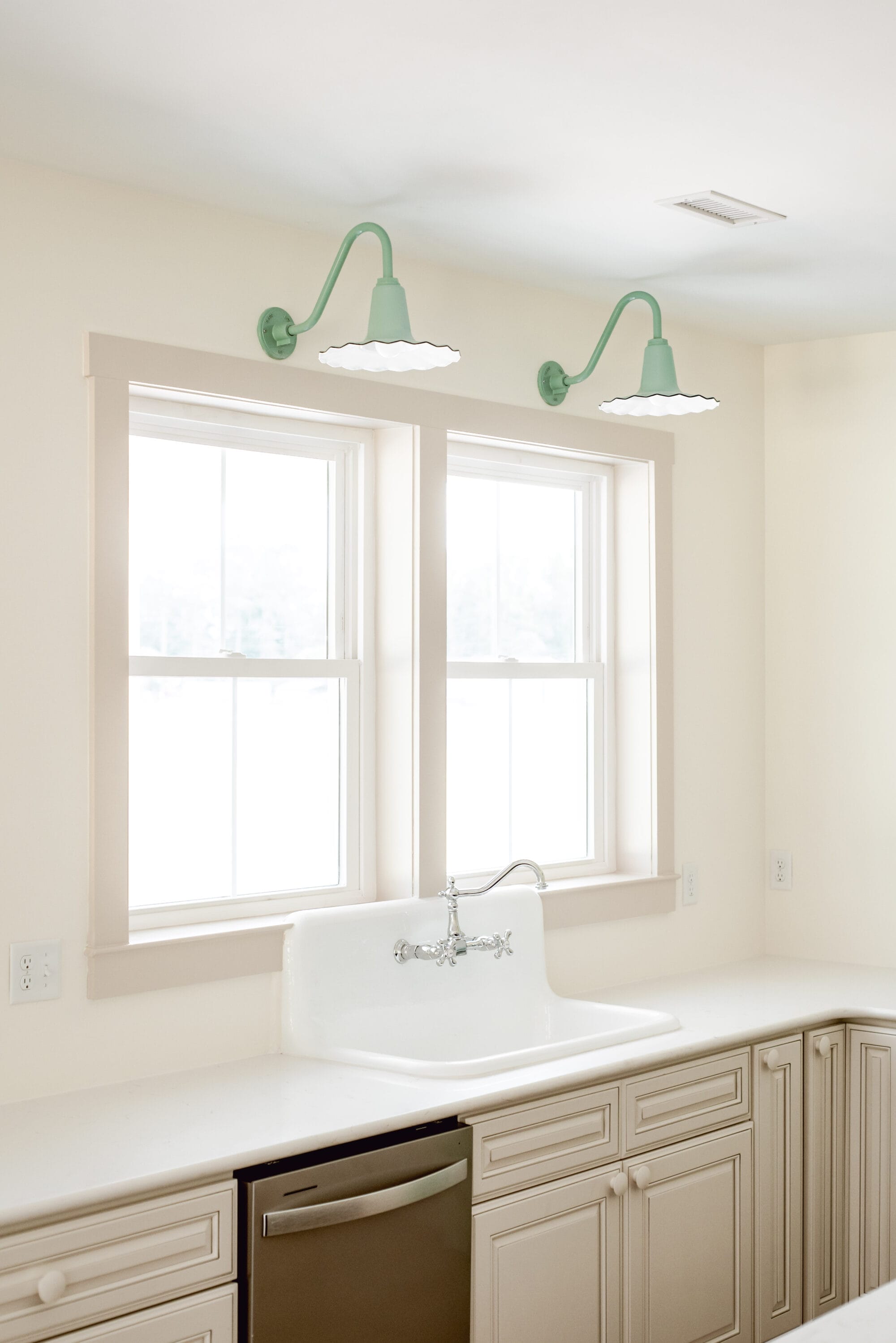 jadeite green seaside sconce lights from Barn Light Electric over the kitchen sink window