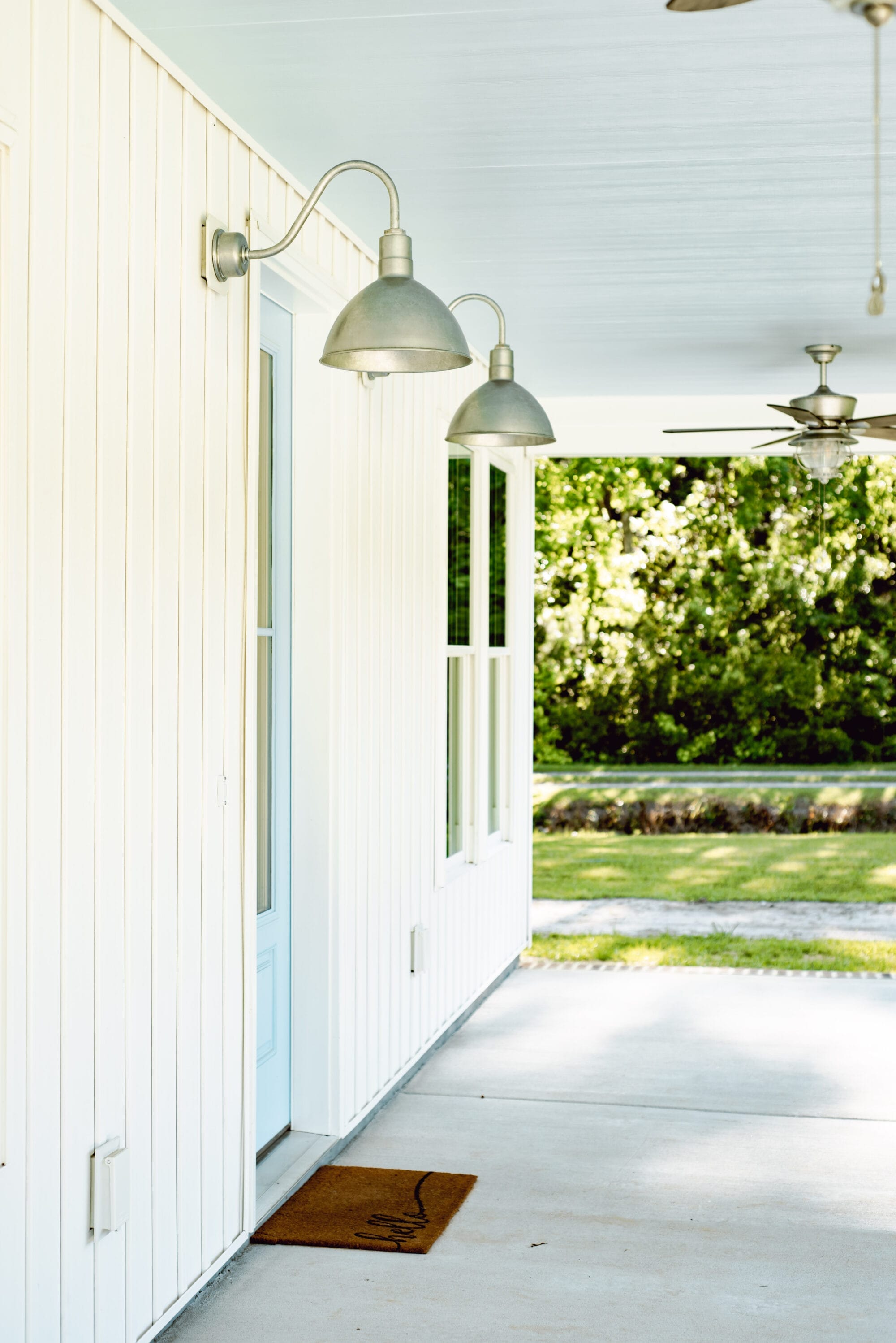 covered front porch with haint blue ceiling and galvanized lights