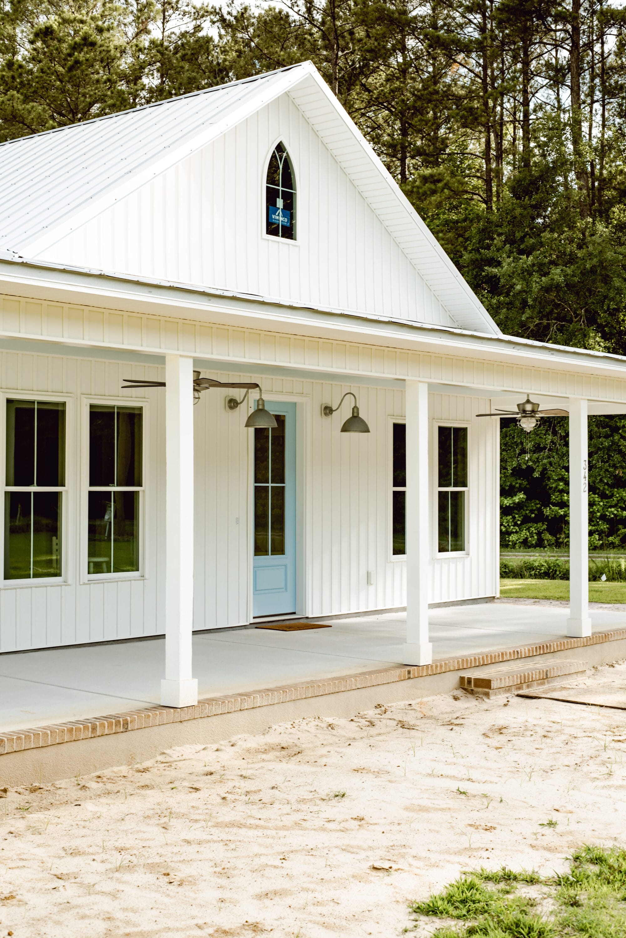 pointed arch window on a white country cottage inspired by American Carpenter Gothic style architecture